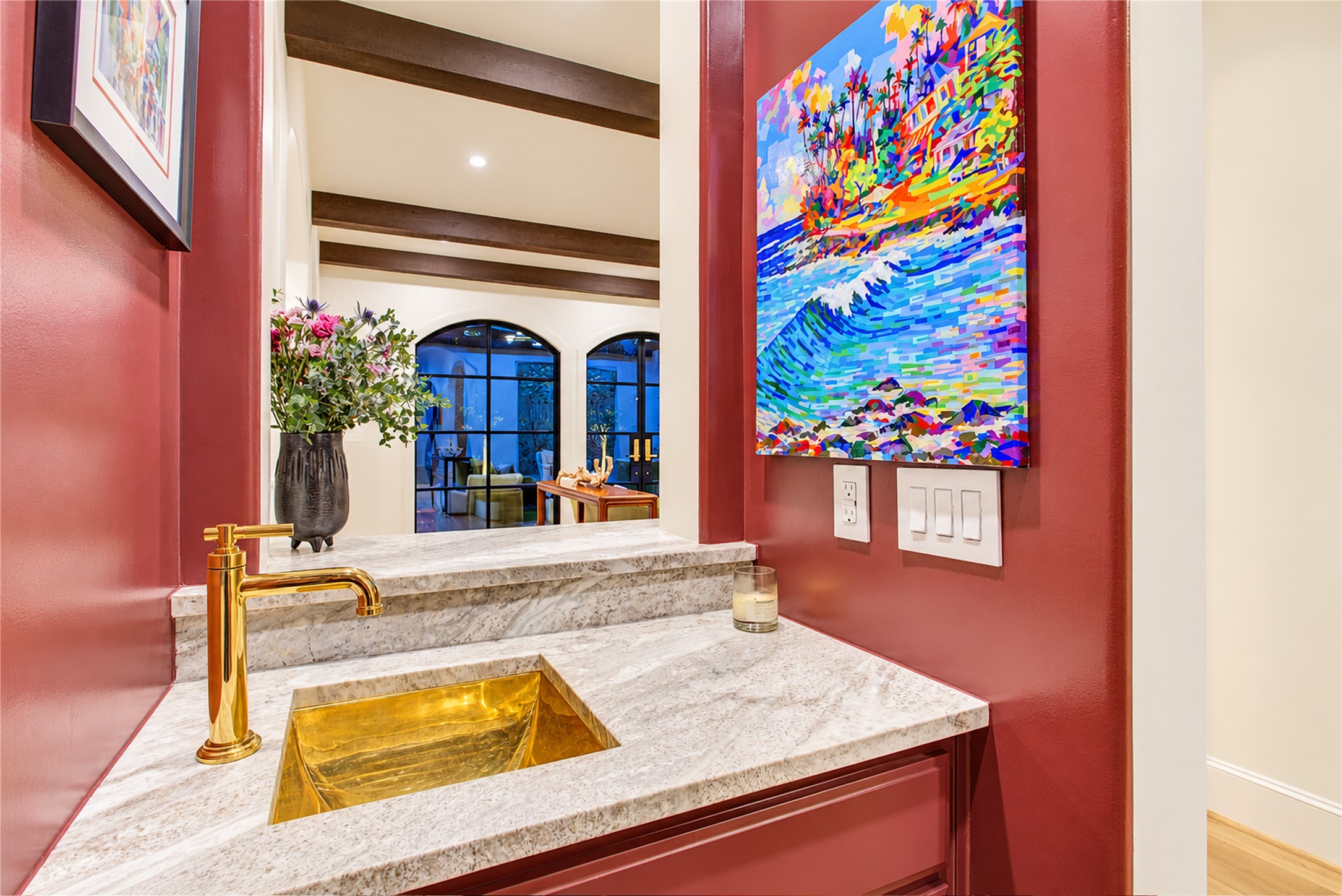 A custom unlacquered brass statement sink, Newport Brass faucet, and leathered Fantasy Brown dolomite elevate this bespoke wet bar.