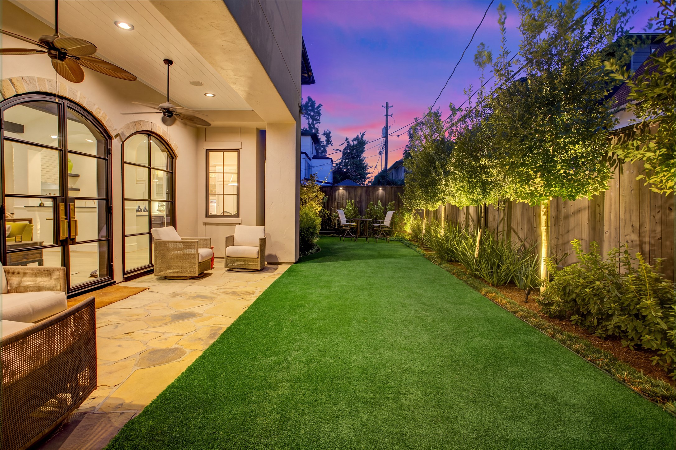 Eight newly planted trees, LED landscape lighting, and full fencing enhance the privacy and appeal of this outdoor retreat.