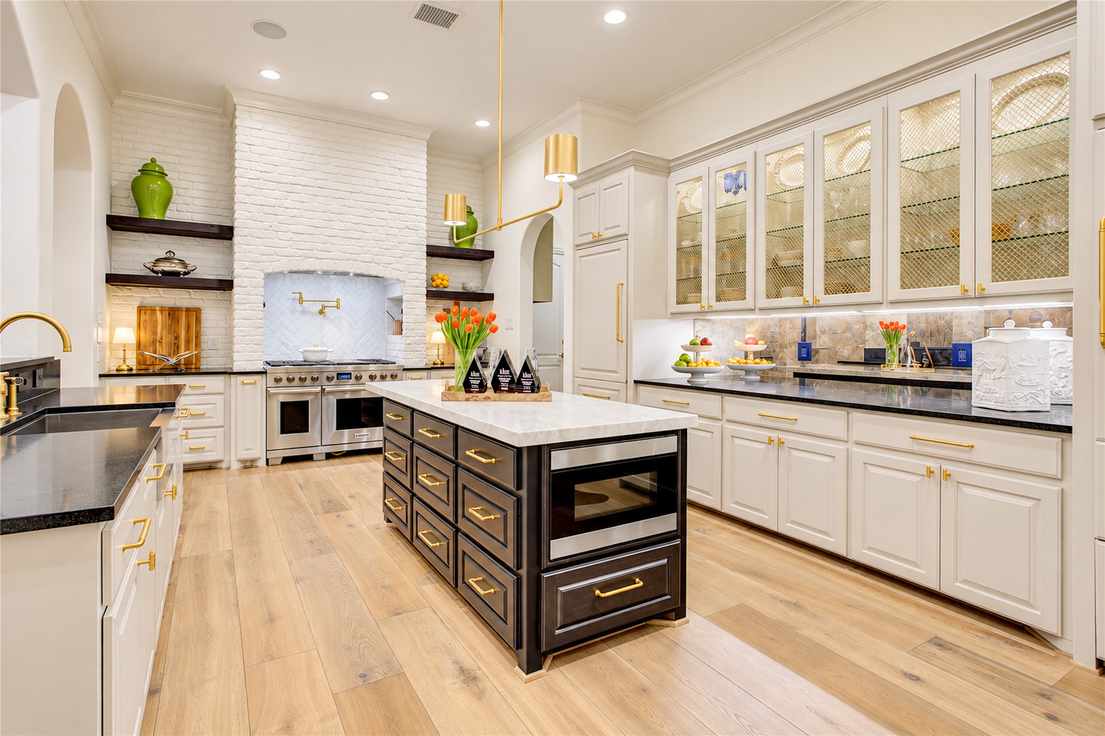 A stunning Taj Mahal quartzite island offers generous seating and convenient storage in this thoughtfully designed kitchen.