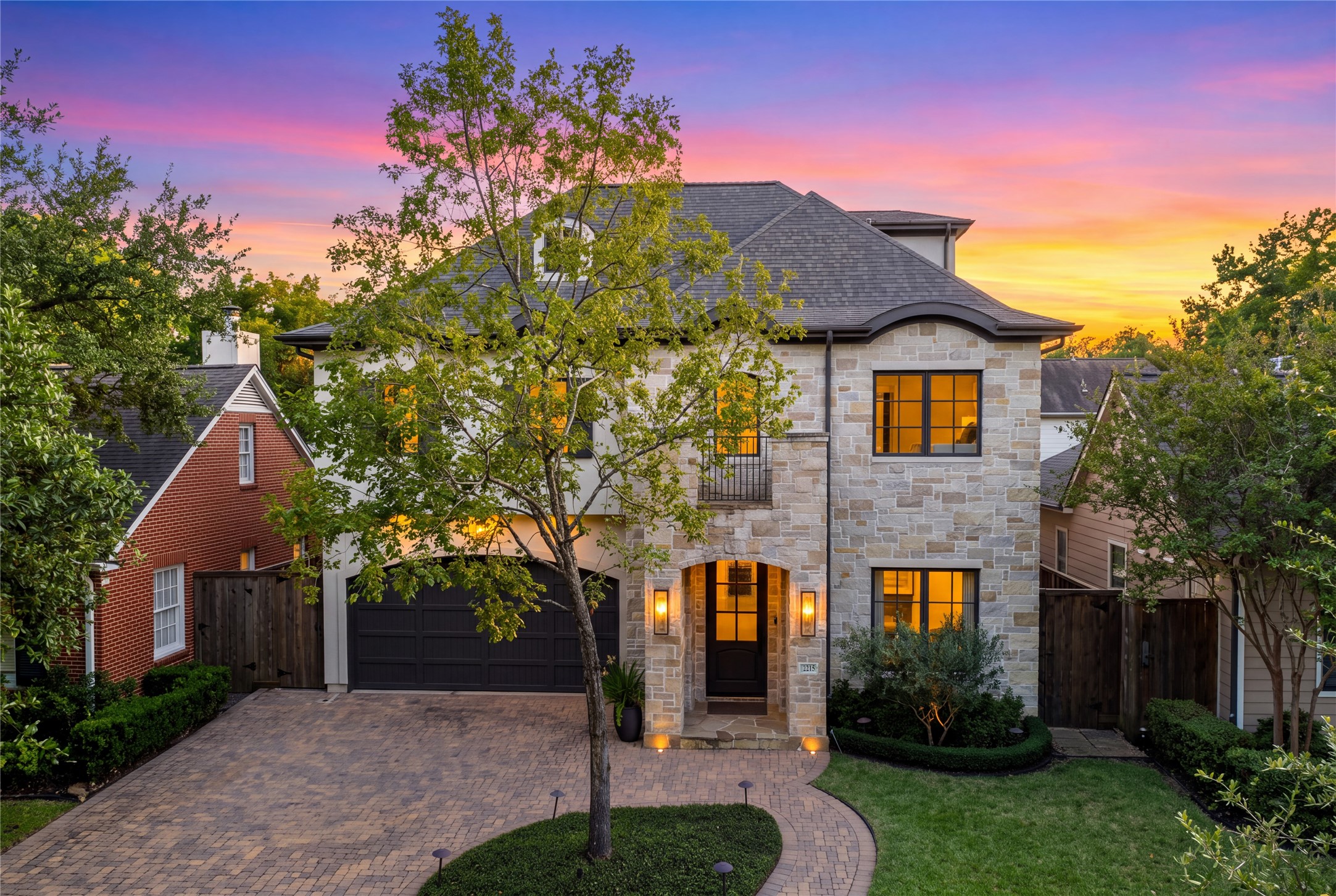 Classic gas carriage lights by Visual Comfort accentuate the homes exterior with refined architectural detail.