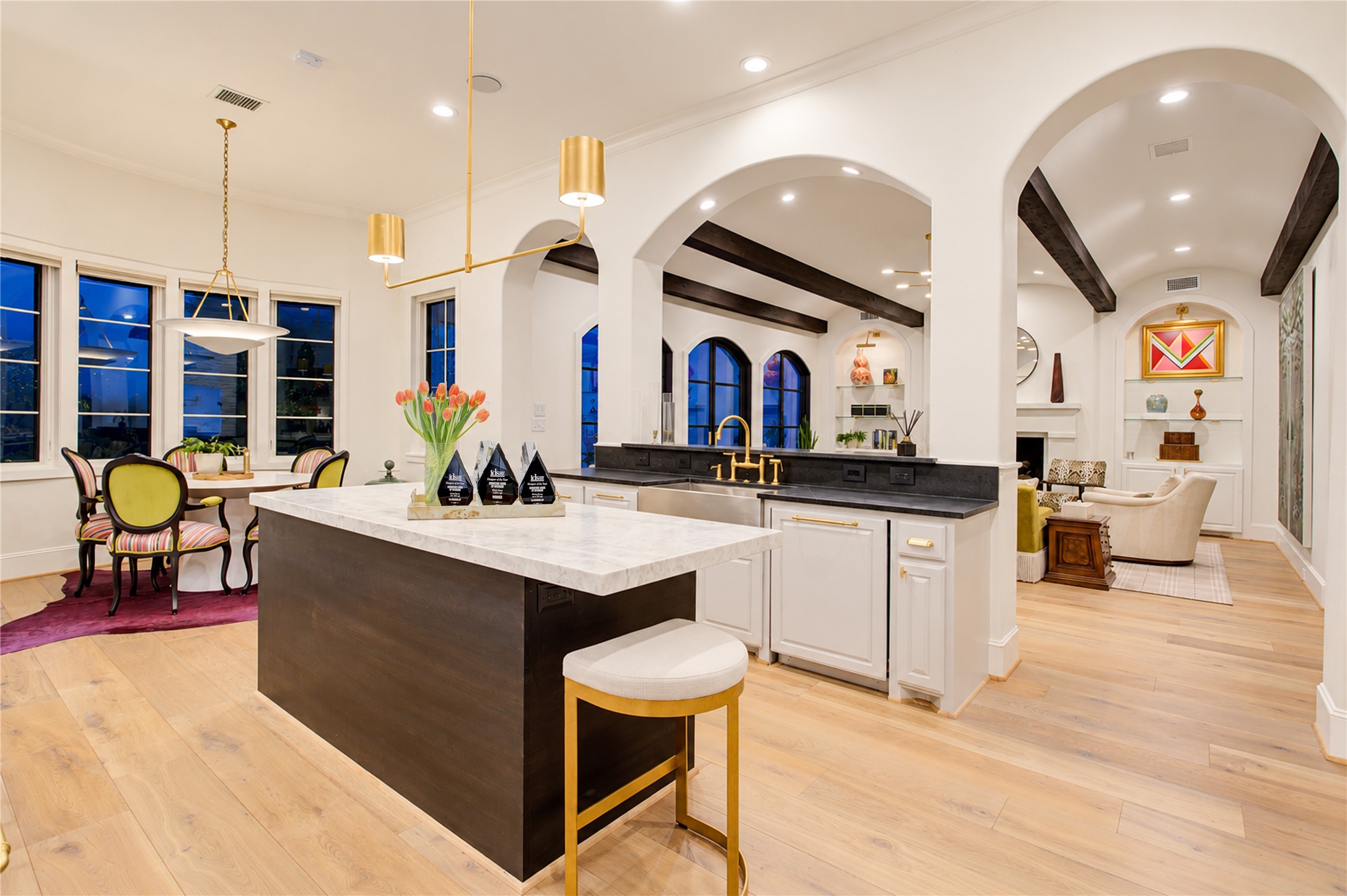 11-foot ceilings and wide-plank white oak floors enhance the kitchens open flow into the breakfast and living rooms.