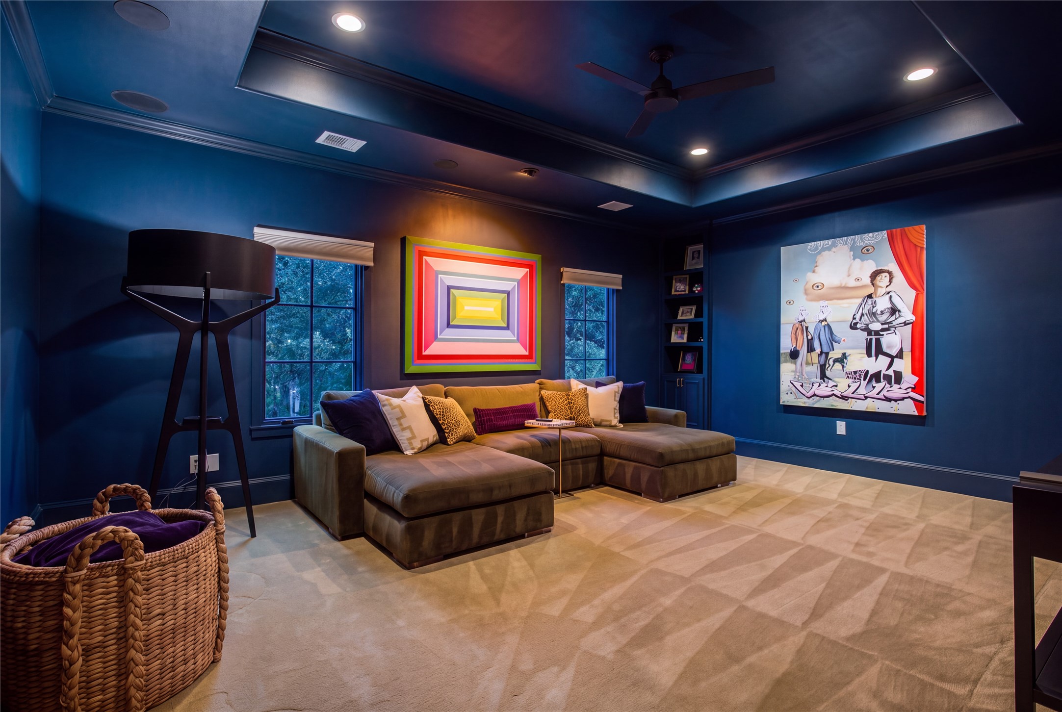A spacious media retreat featuring a 10-foot tray ceiling, in-ceiling audio, and room for oversized sectional seating.