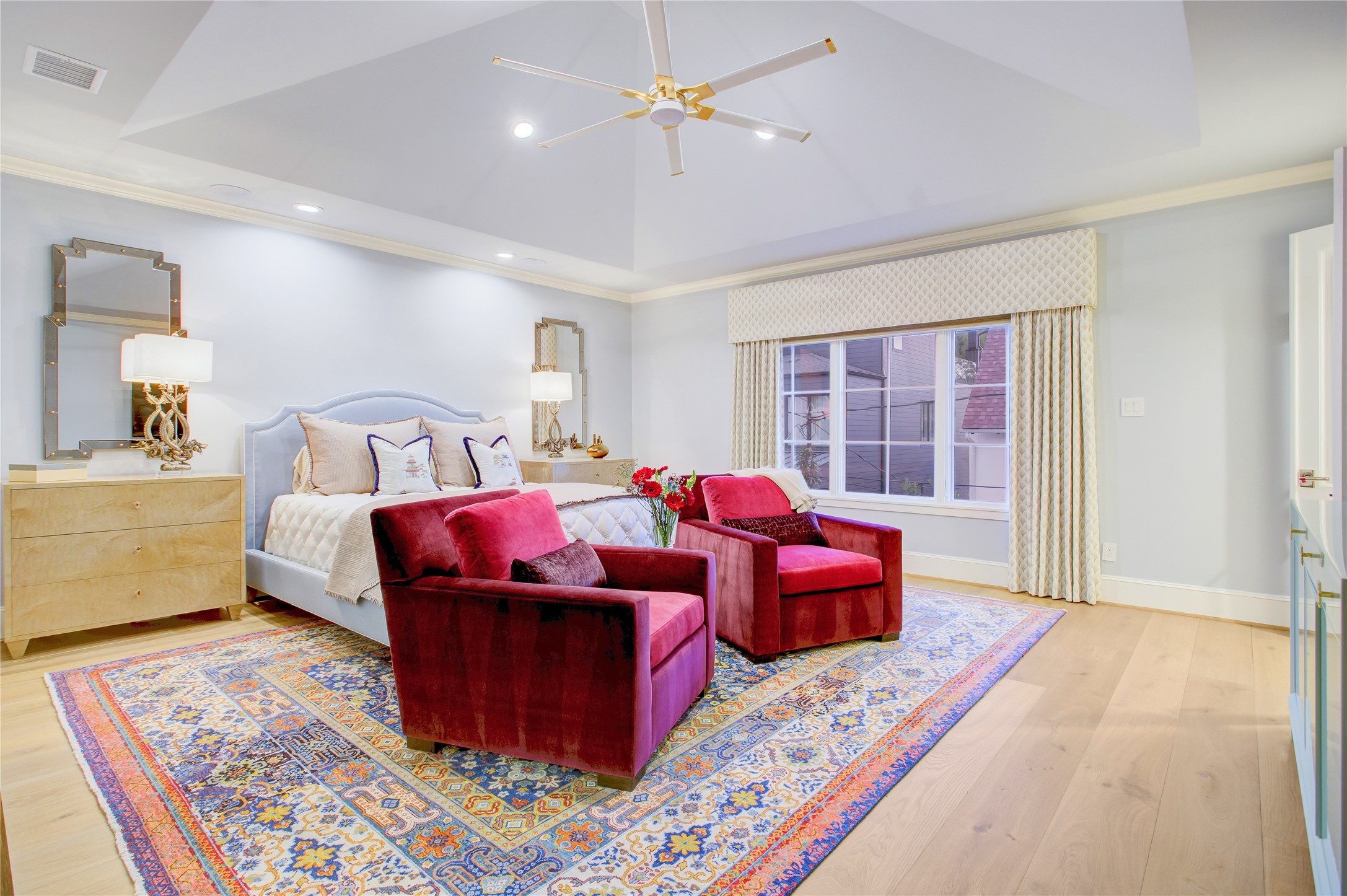 A vaulted 12-foot ceiling crowns the primary suite, with recessed reading lights and ample room for a spacious sitting area.