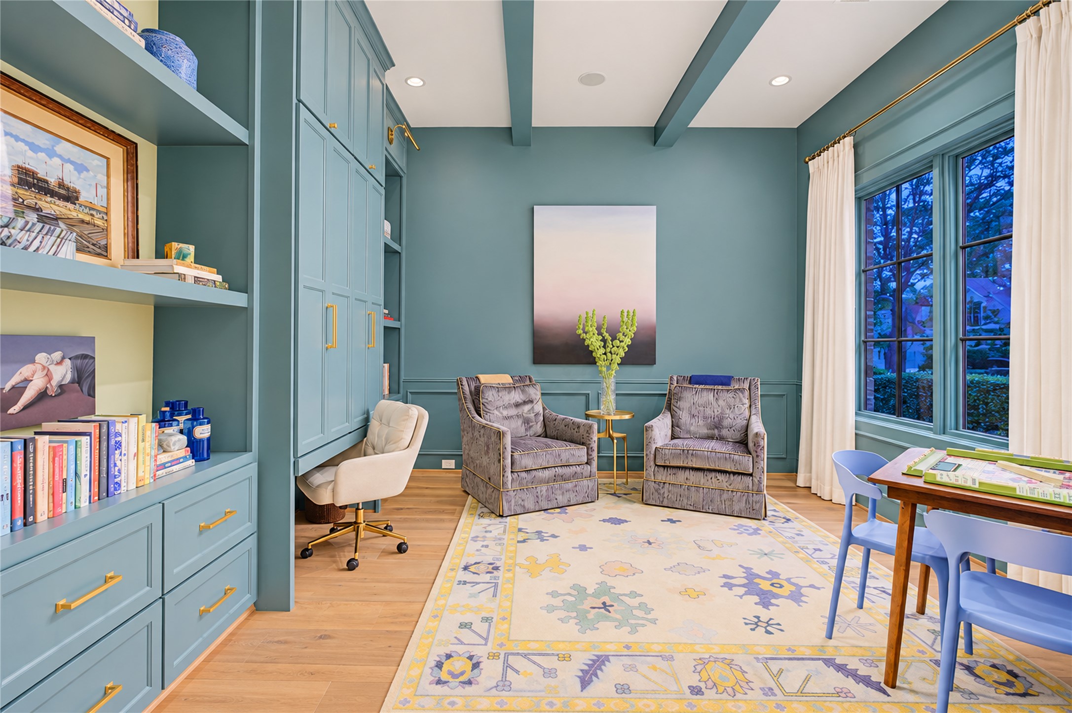 Floor-to-ceiling soft-close built-ins conceal a bi-fold desk system, blending refined millwork with discreet functionality.