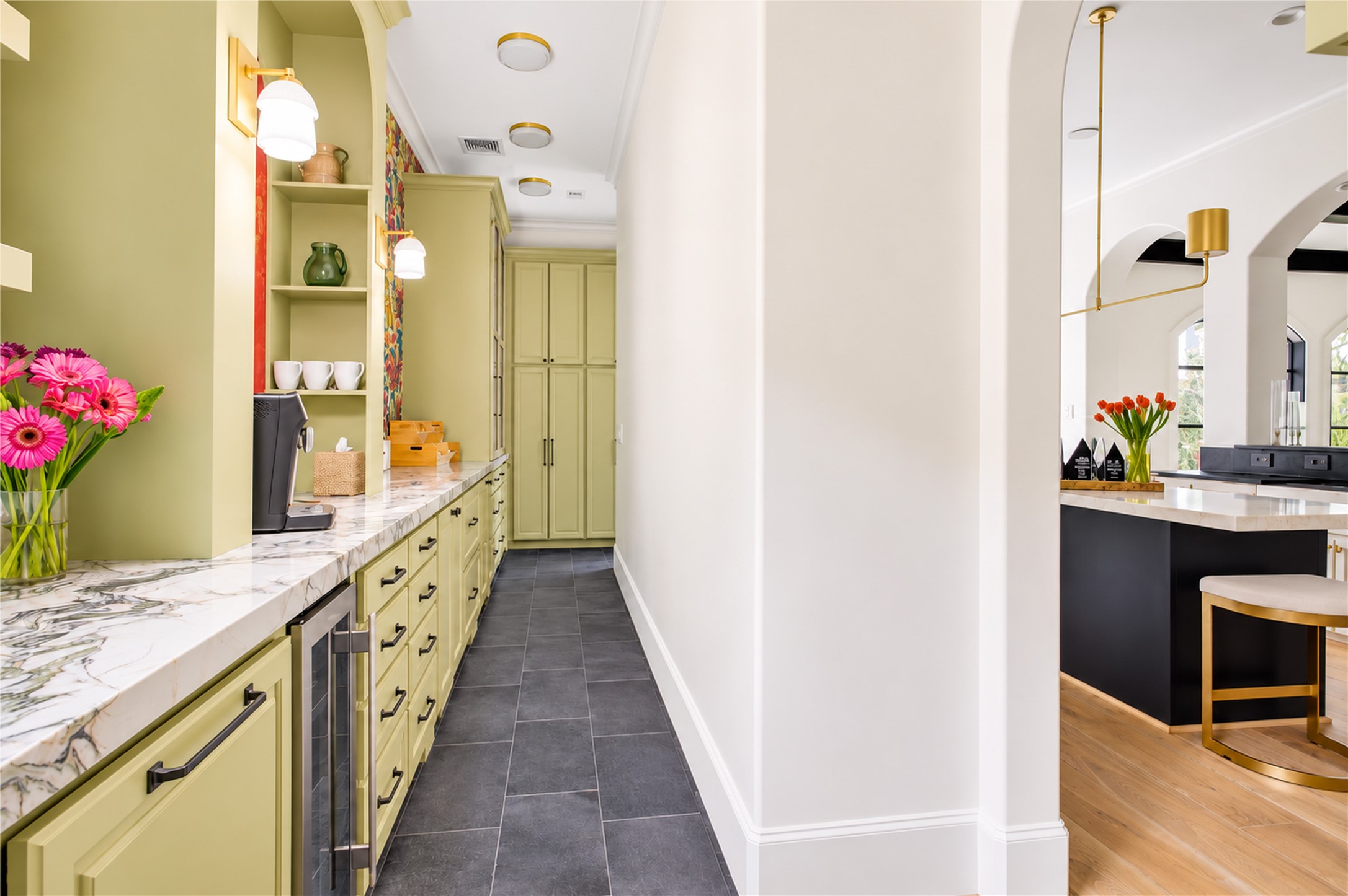 Floor-to-ceiling cabinetry maximizes storage while lending a seamless, tailored aesthetic to this dedicated prep kitchen.