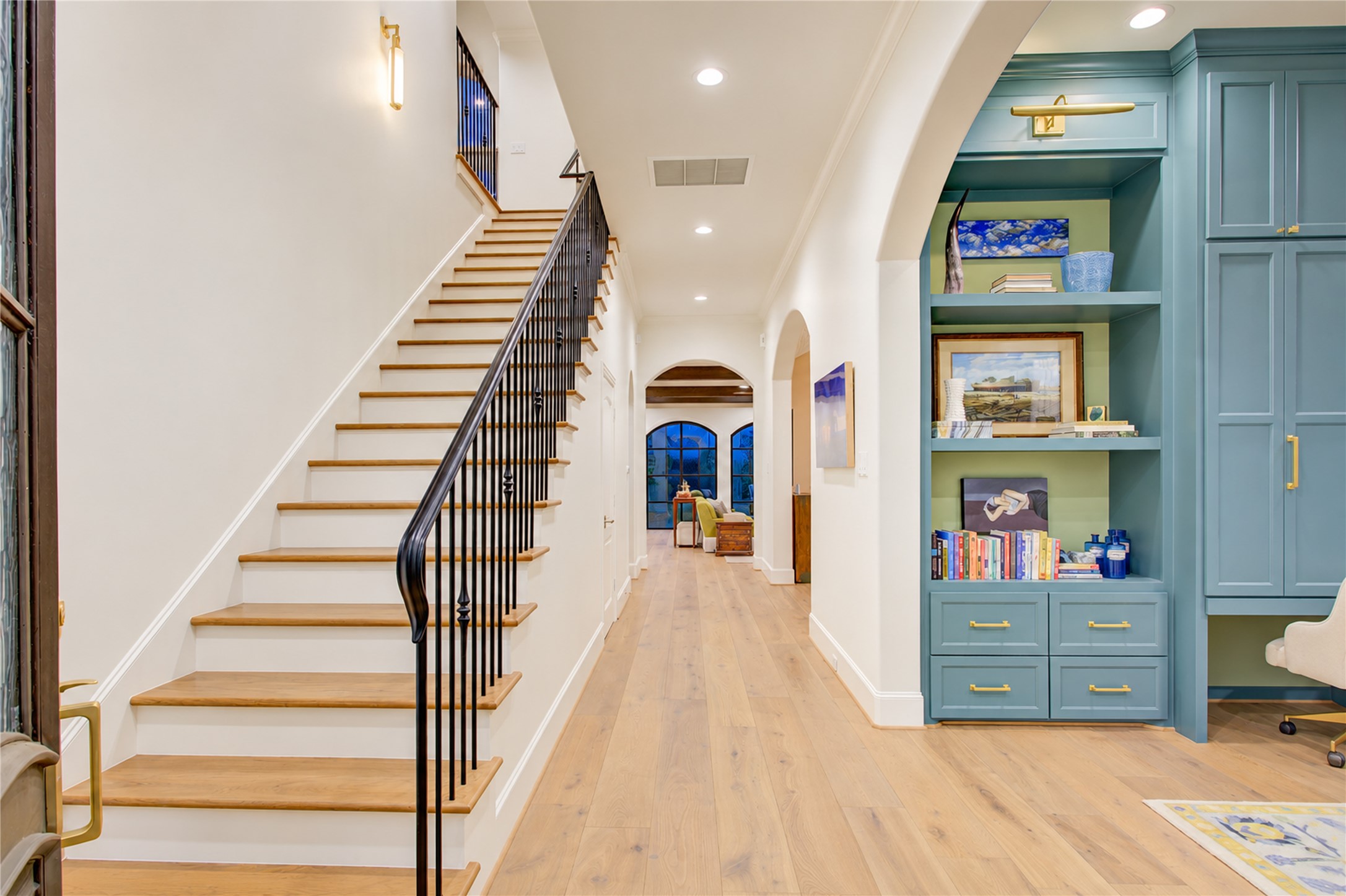 Refined detailing defines this staircase, showcasing hardwood treads, a lambs tongue handrail, and classic iron balusters.
