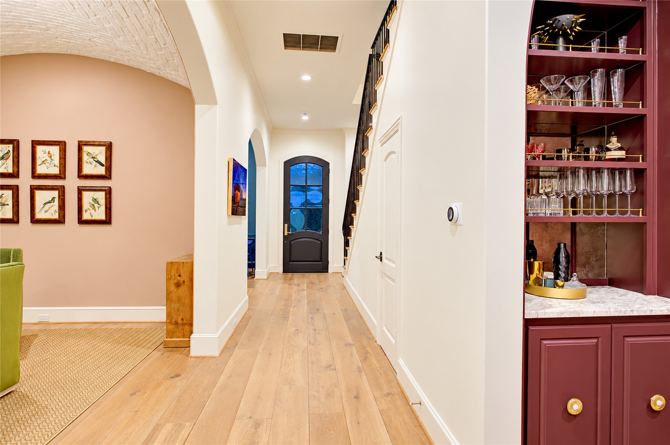 Soaring ceilings and graceful arched openings create an elegant introduction to this distinguished residence.