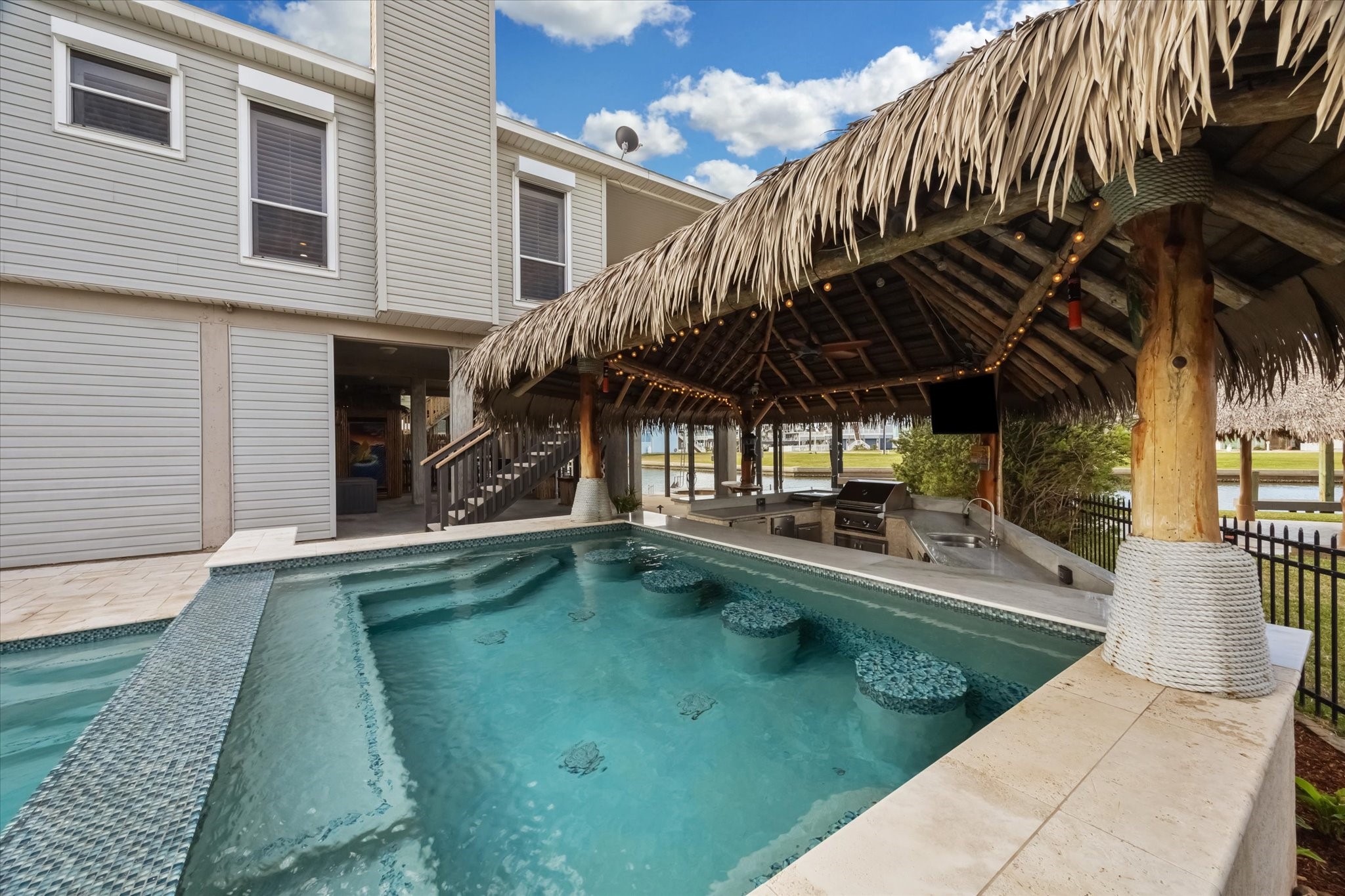 The cabana includes a built-in bar and grill area, perfect for entertaining. The setting offers a resort-like feel. The cabana includes a built-in bar and grill area, perfect for entertaining. The setting offers a resort-like feel.