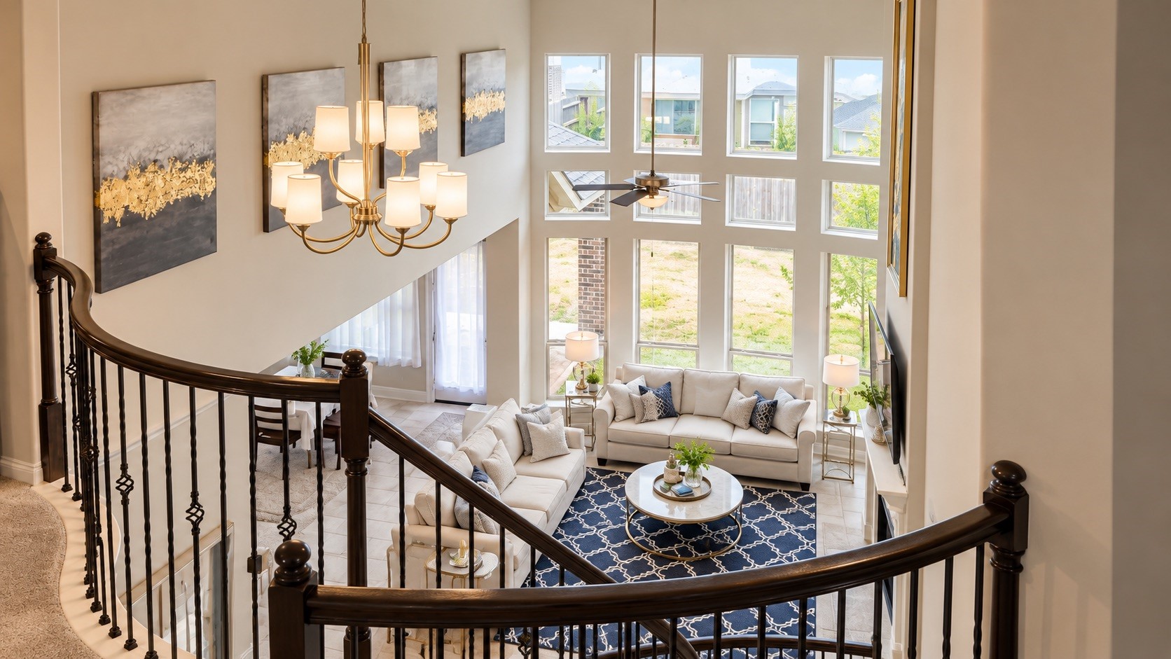 Second-Floor Overlook  Sweeping upstairs view overlooking the two-story living room and impressive wall of windows. [Virtually Staged & Rendered]