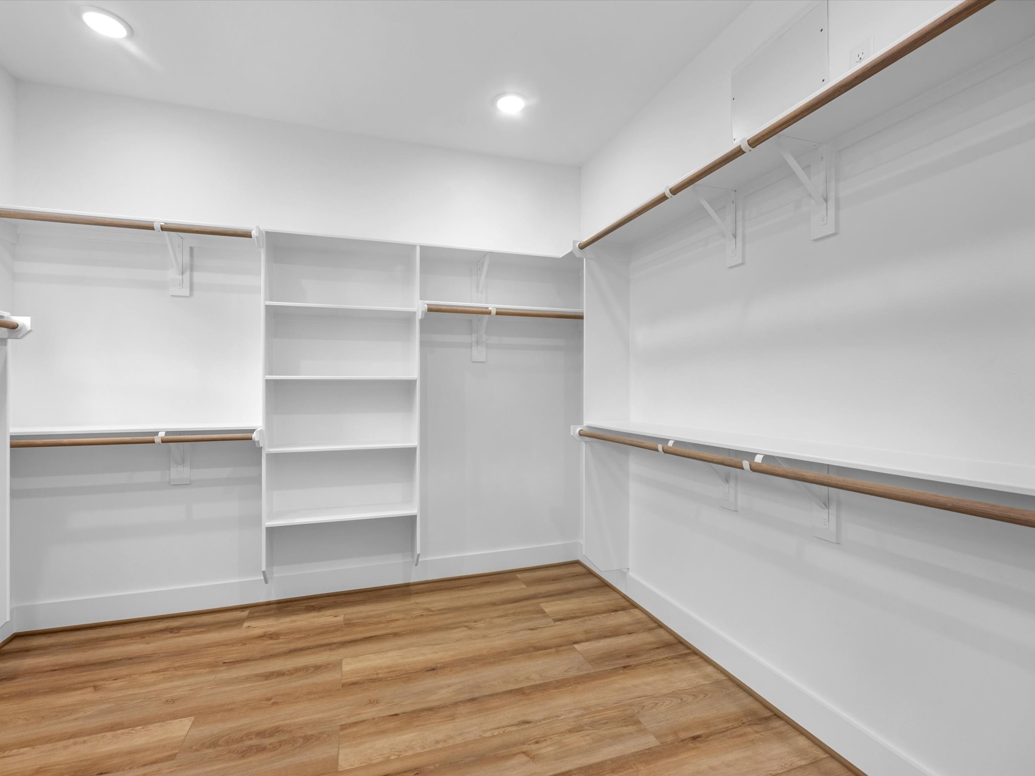 Spacious walk-in closet  for primary bedroom offering plenty of room for clothing, shoes, and accessories. The generous size provides excellent storage while keeping everything organized and easily accessible.