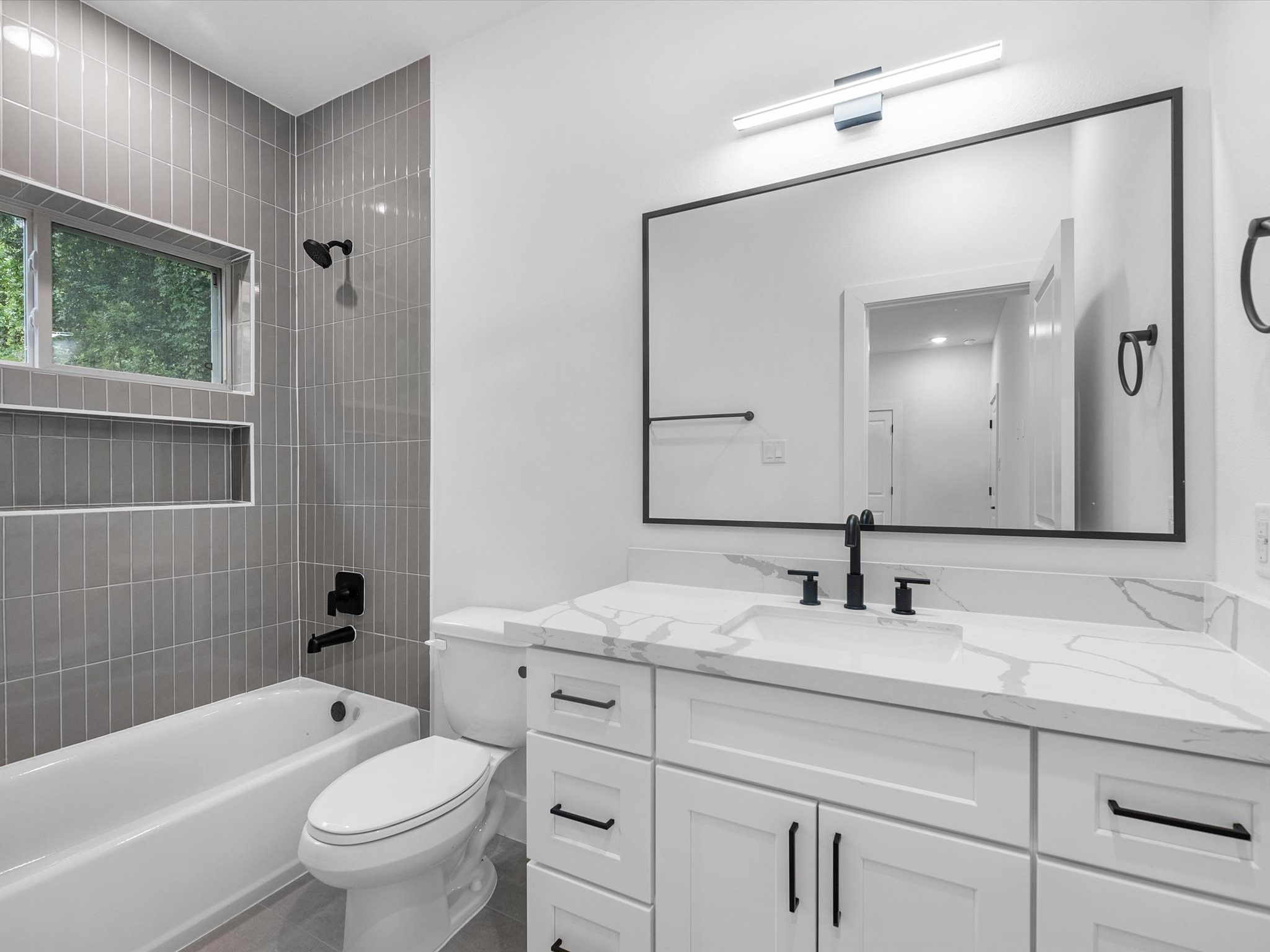 Beautiful first-floor full bathroom conveniently connected to the bedroom, offering privacy and comfort. Each bedroom in the home features its own private full bathroom, providing a functional and comfortable layout for everyone.