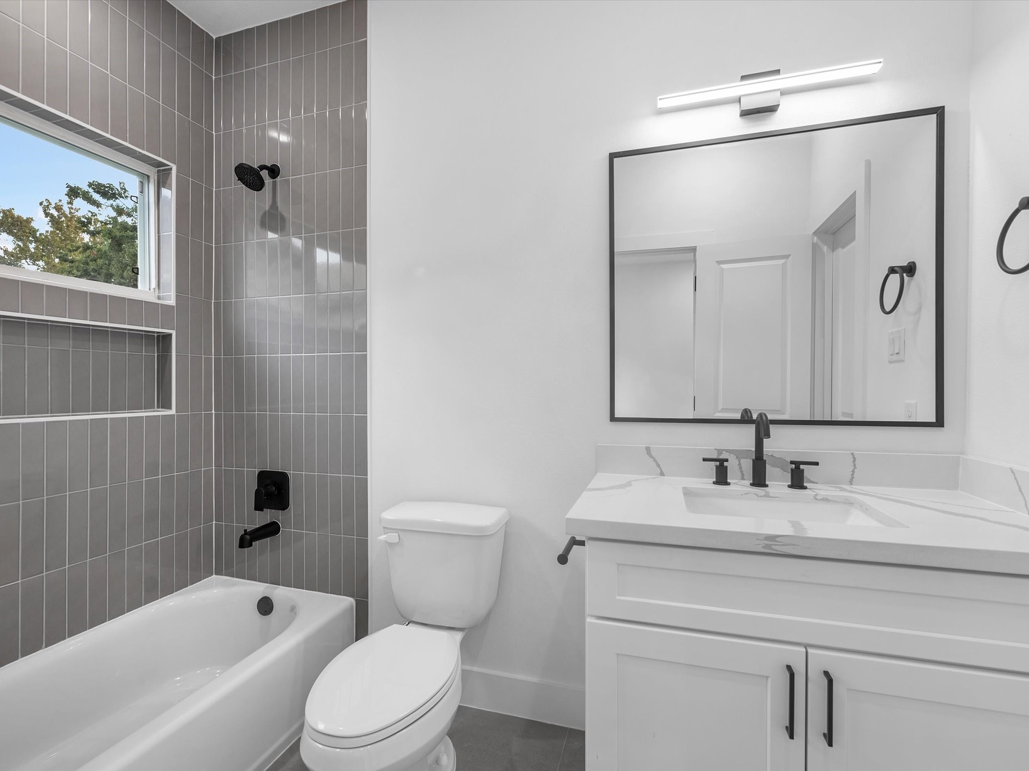 Beautiful full bathroom connected to the second third-floor bedroom, offering privacy and convenience. Every bedroom in the home features its own private full bathroom, creating a comfortable and functional layout for everyone.