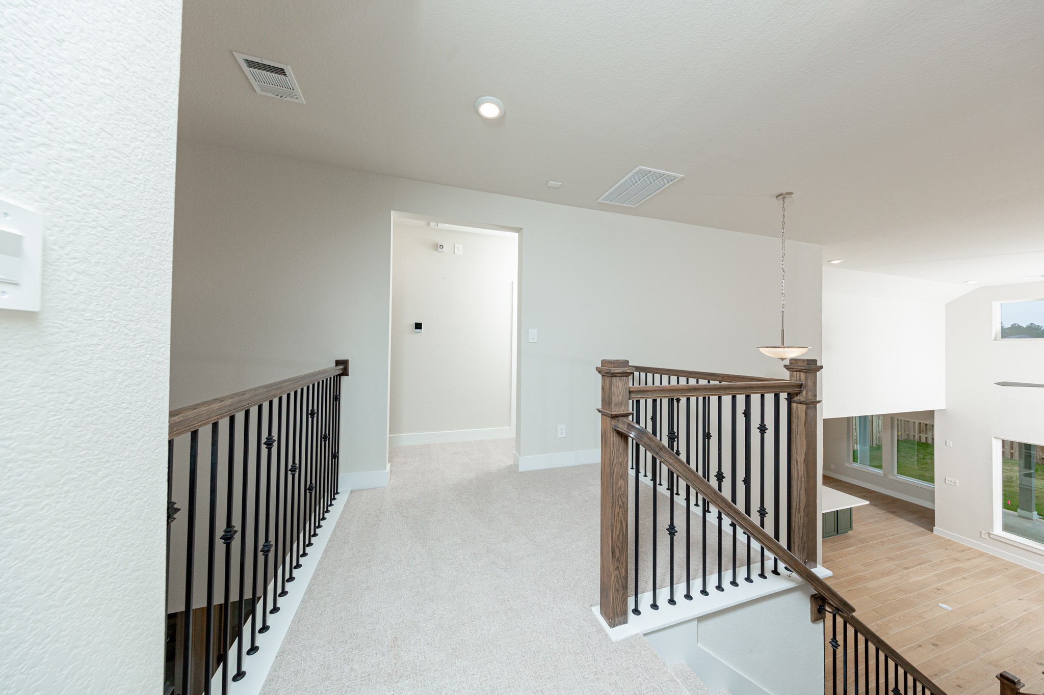 Game Room looking out towards stairs and hallway leading to secondary bedrooms and bathroom.