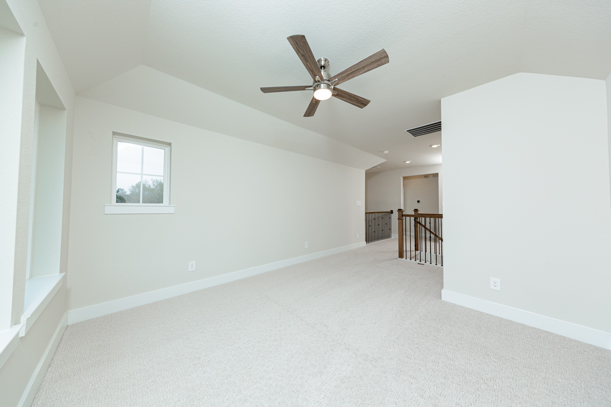 Game Room looking out towards stairs and hallway leading to secondary bedrooms and bathroom.