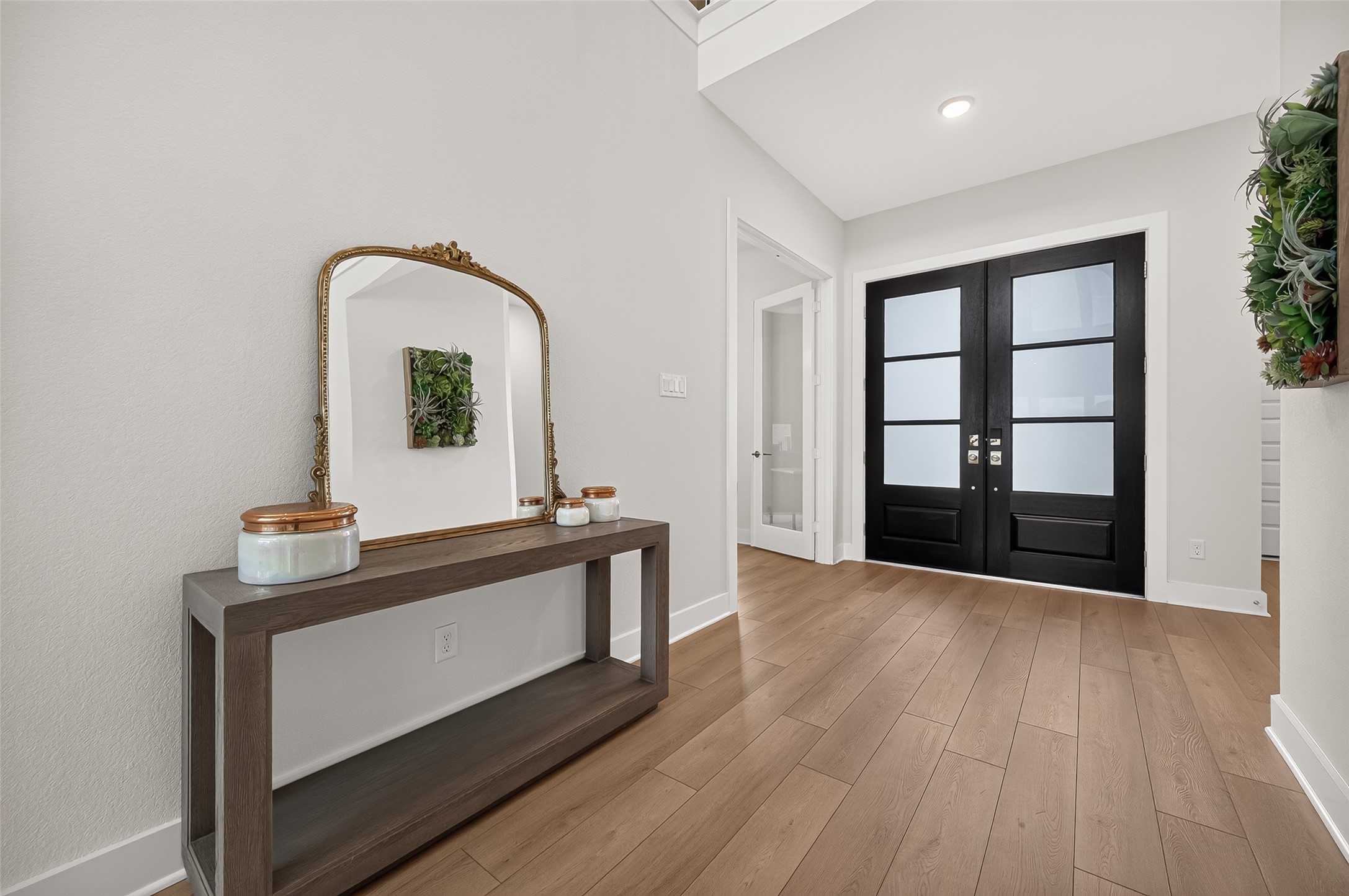 Bright and Open foyer! Gorgeous floating wood-look plank flooring flows seamlessly throughout the main living areas, complemented by plush carpeting in the bedrooms and upstairs for an added touch of warmth and comfort.