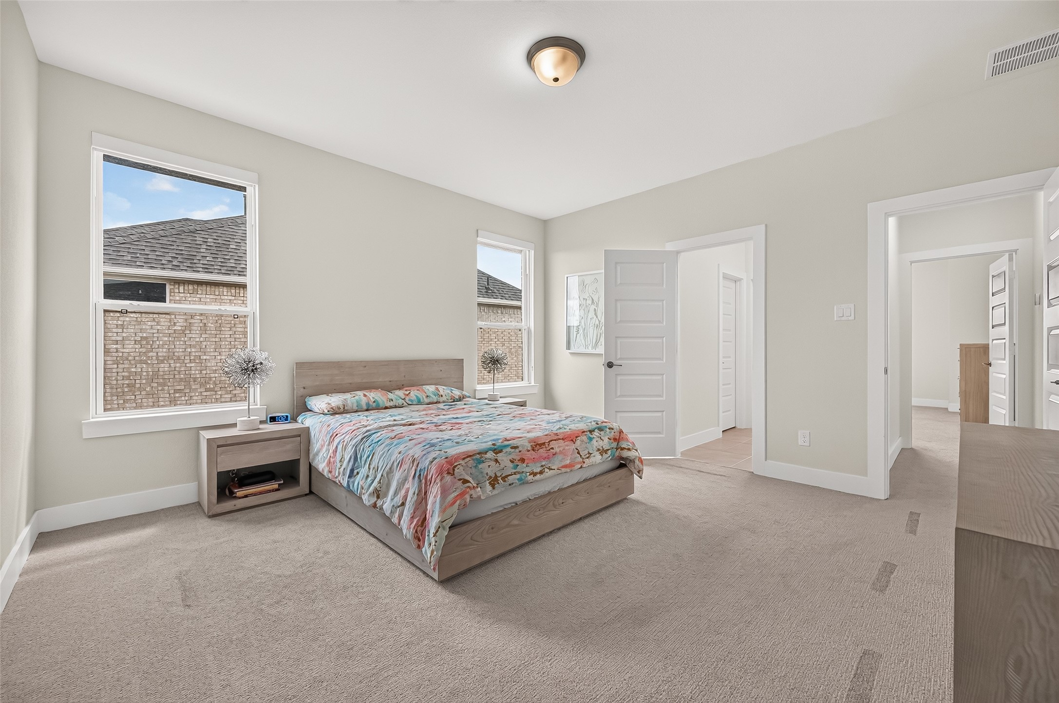 Three additional generously sized bedrooms are located upstairs, all offering spacious walk-in closets. Bedroom shown share a Jack-and-Jill bath!