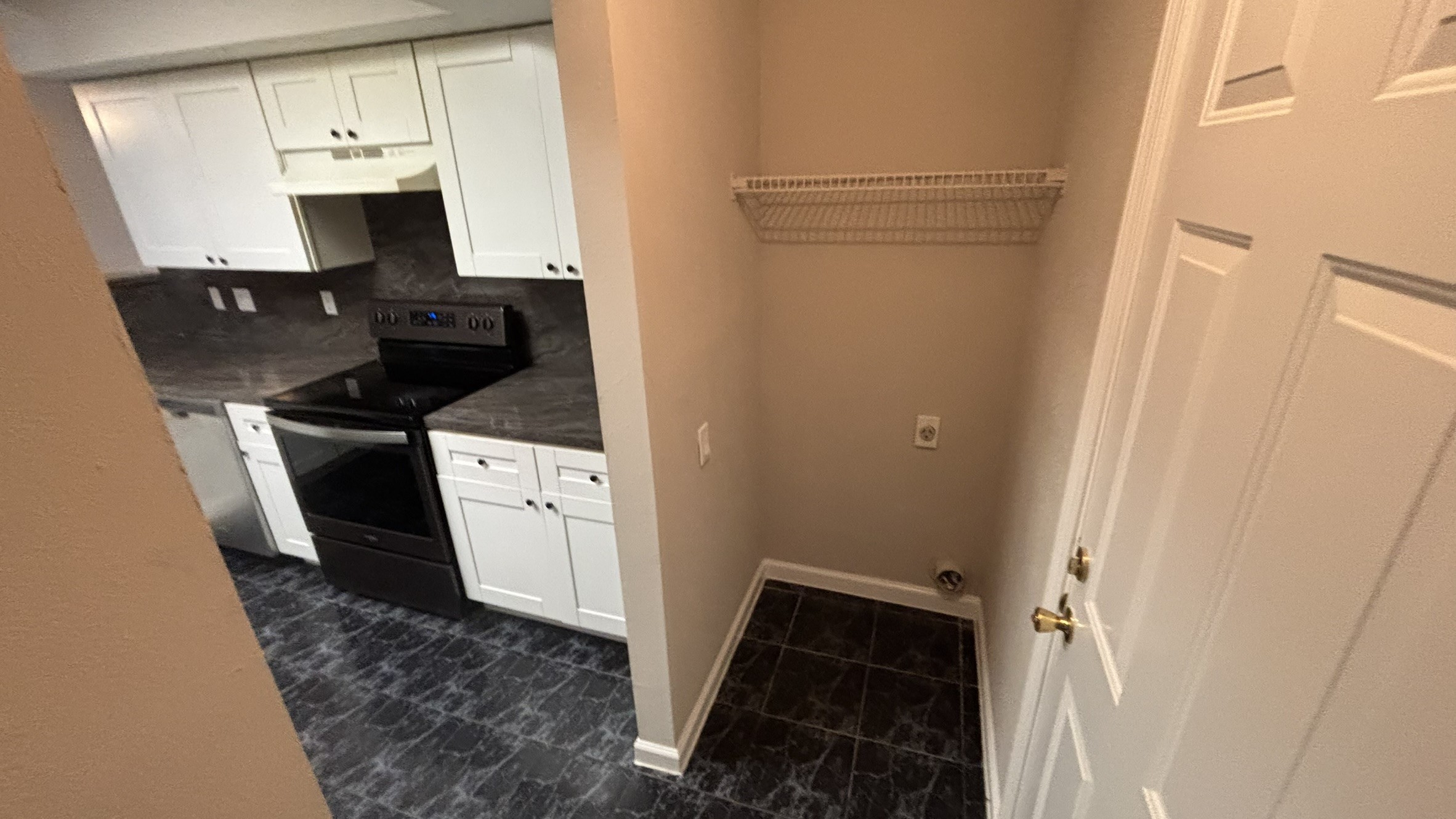Laundry room connected to kitchen and garage.