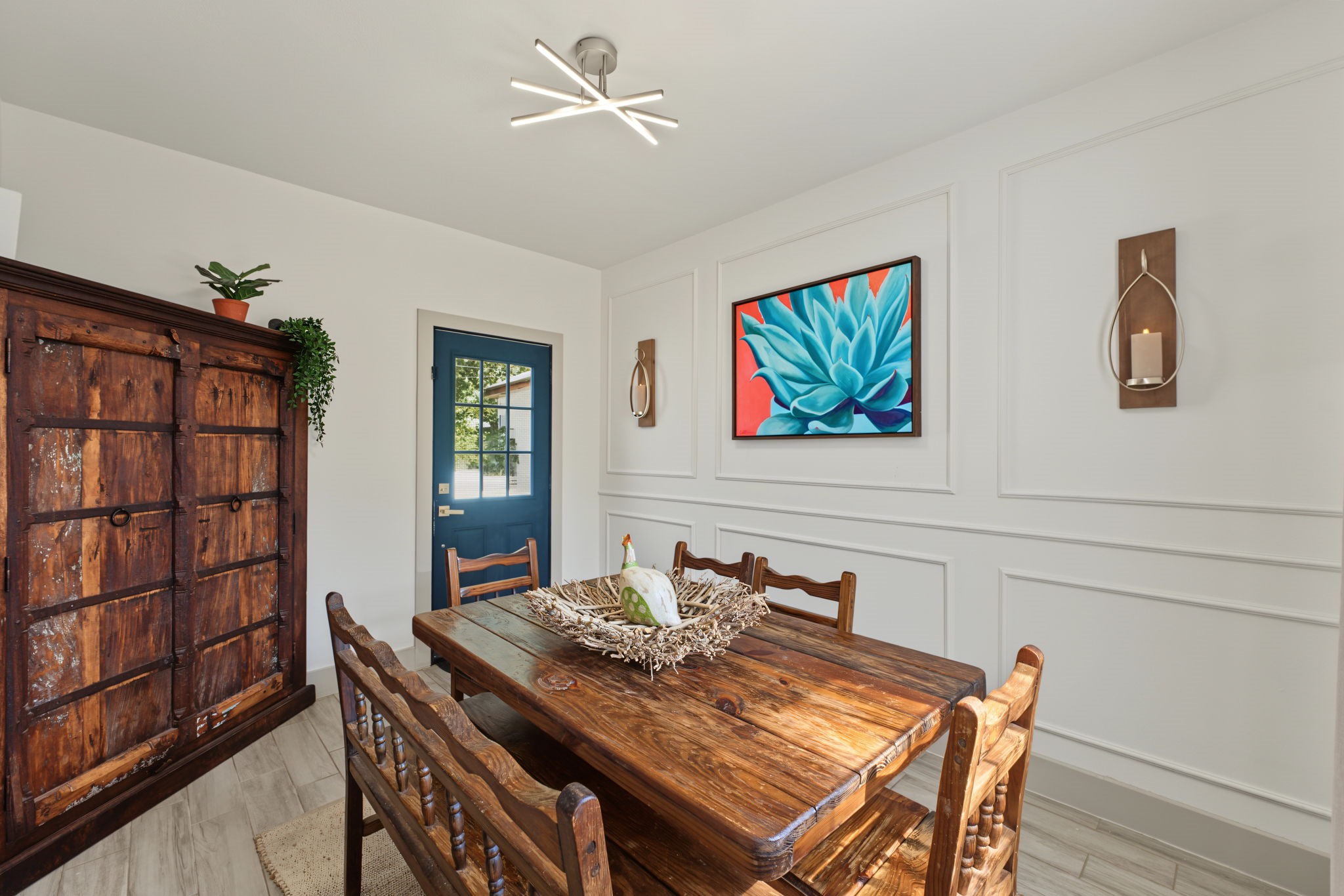 Flex room with French doors, picture-frame molding and a modern light fixture opens to the deck and pool! Use it as a dining room, game room or home office.