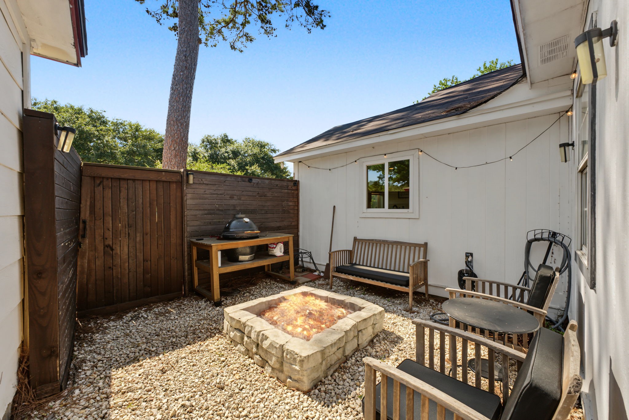 Private fire pit courtyard with pea gravel and privacy fencing. S'mores night, anyone?