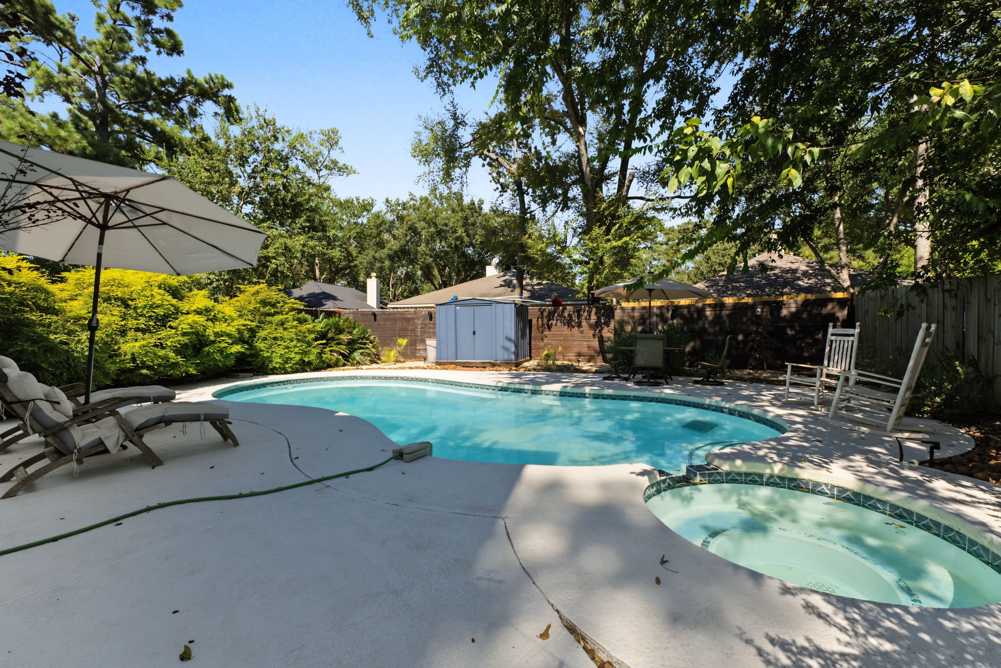 Sparkling pool with plenty of room to lounge under mature shade trees, plus a storage shed for pool gear!