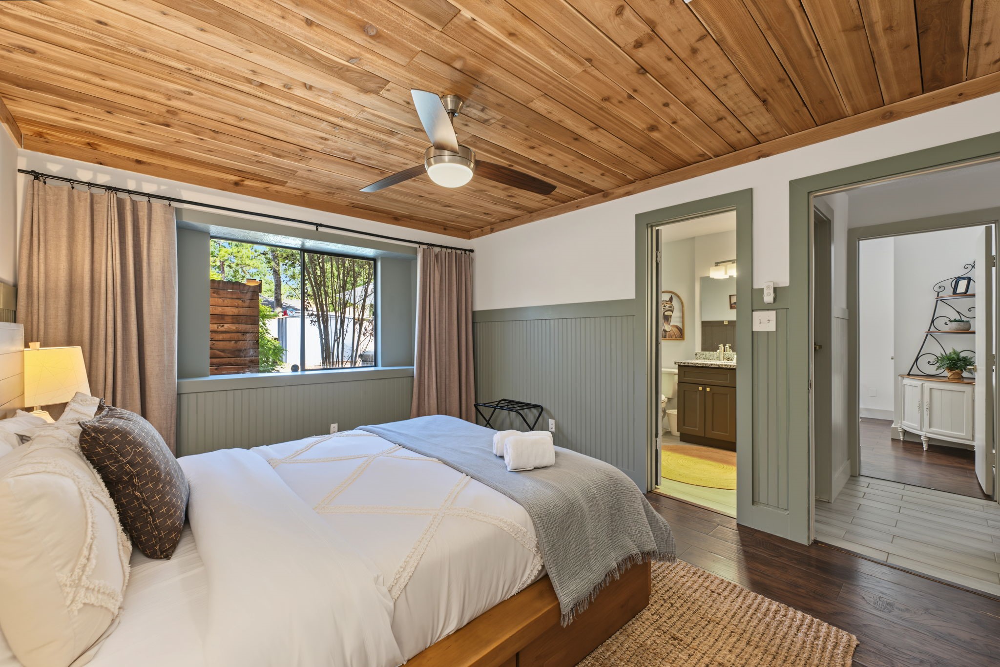 Primary retreat offers a large picture window and en-suite access.