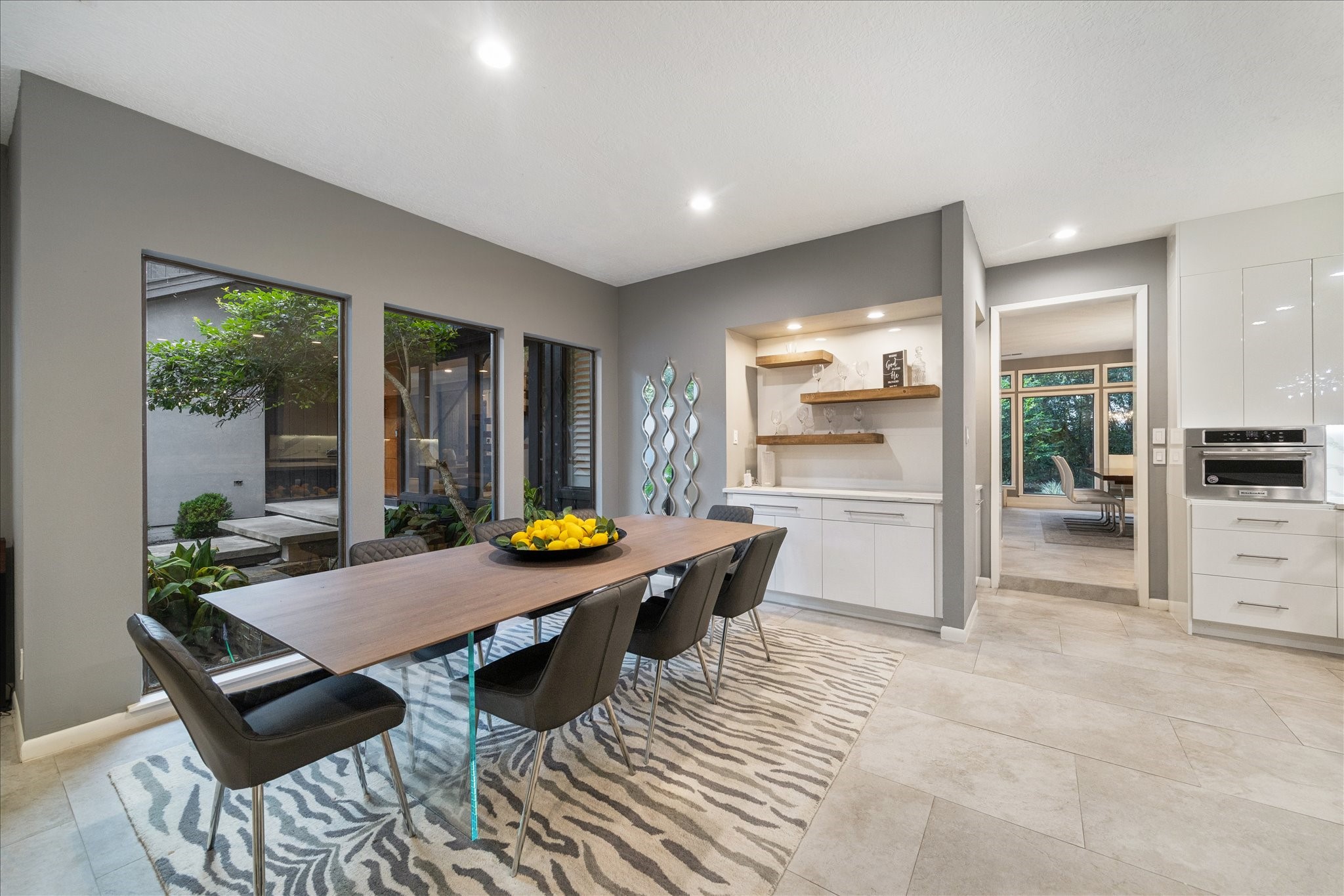 This beautiful breakfast room features large windows with garden views and opens to the kitchen
