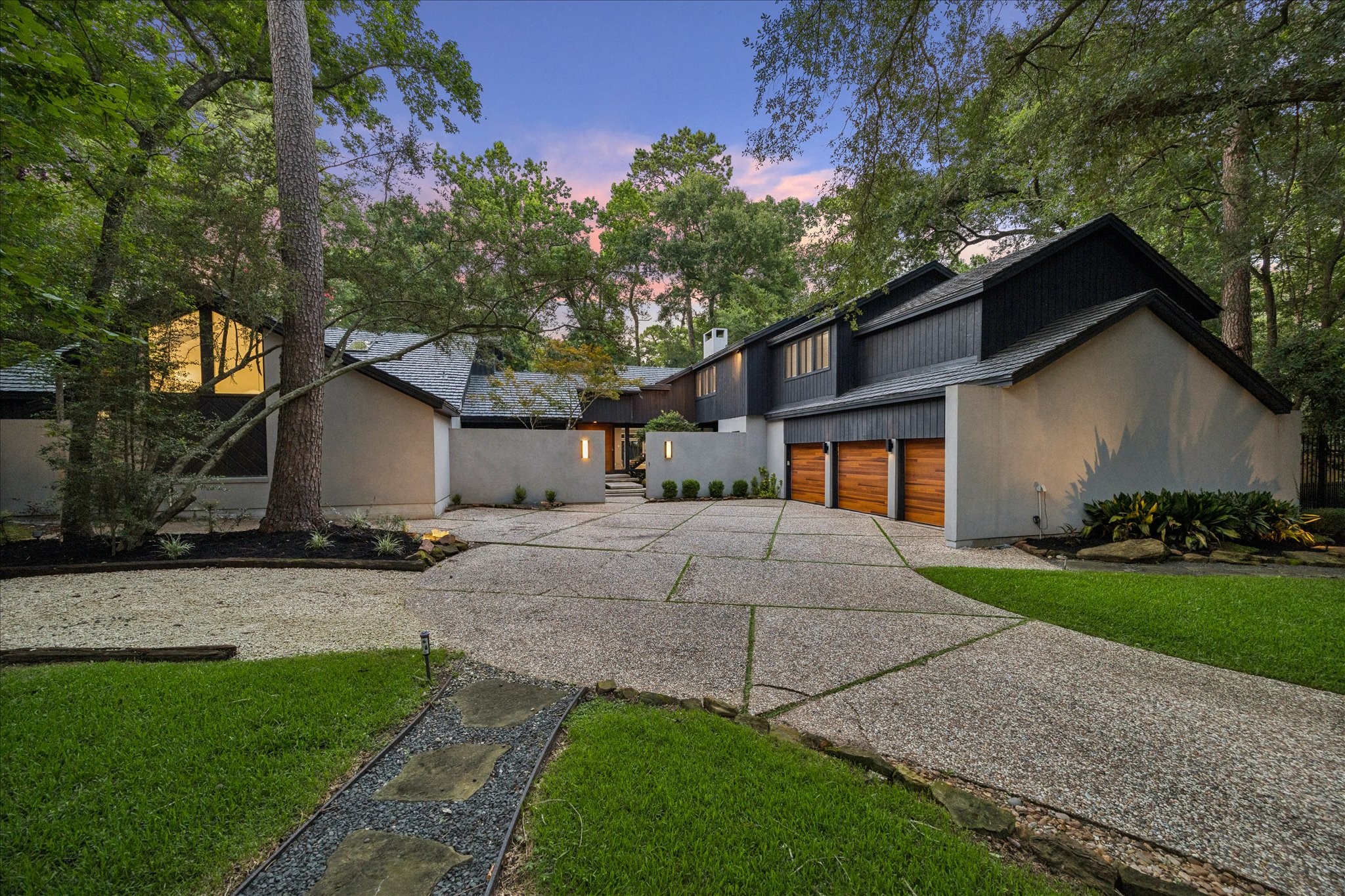 Welcome to 2411 Oakbank. This home features a sleek exterior with a multi-car garage, nestled in a lush, wooded setting. Its expansive driveway and contemporary architecture create a welcoming, stylish entrance. Welcome to 2411 Oakbank. This home features a sleek exterior with a multi-car garage, nestled in a lush, wooded setting. Its expansive driveway and contemporary architecture create a welcoming, stylish entrance.
