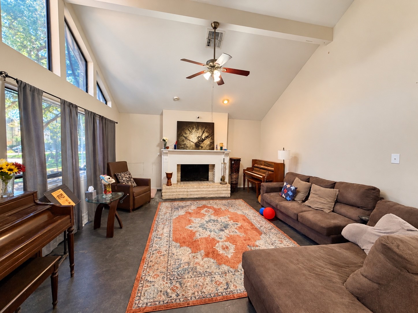 Actual living room/gorgeous windows and natural light with dramatic vaulted ceiling