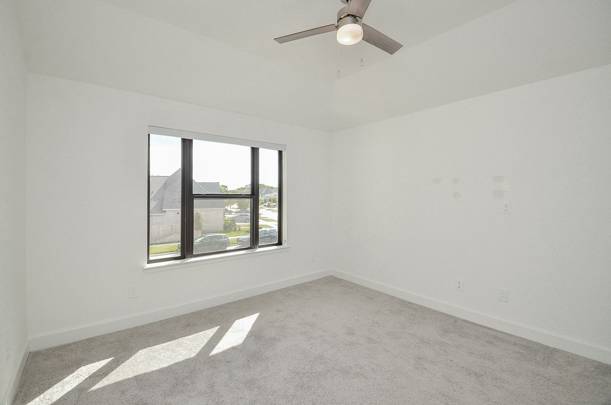 Another bright secondary bedroom offering flexible space for guests or a home office.