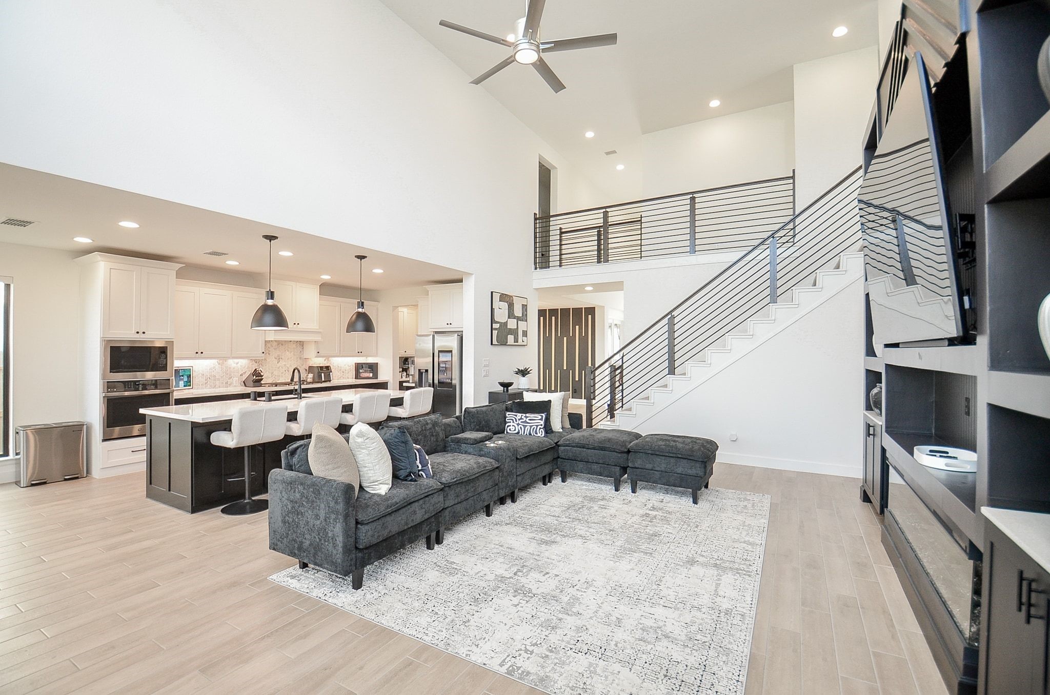 Seamless open-concept design connects the family room, kitchen, and upstairs living areas.
