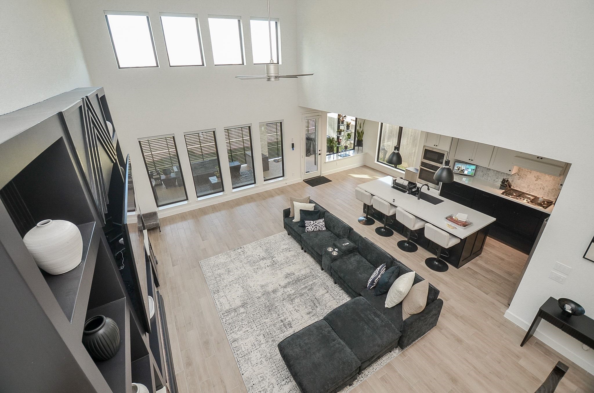 View from upstairs showcasing the dramatic two-story living area and open-concept kitchen.