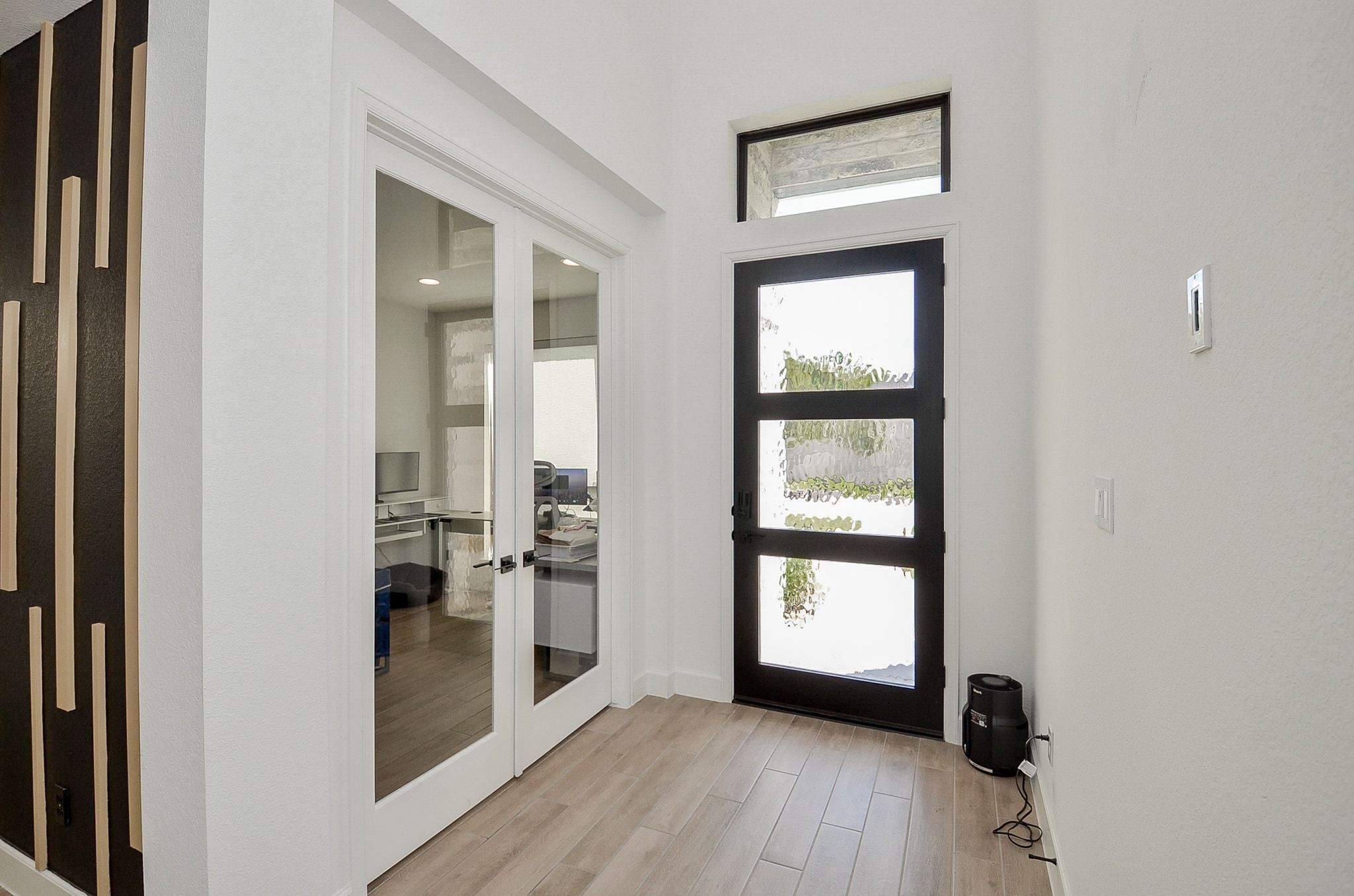 Bright, welcoming entry with stylish flooring and French doors leading to the private study. Bright, welcoming entry with stylish flooring and French doors leading to the private study.