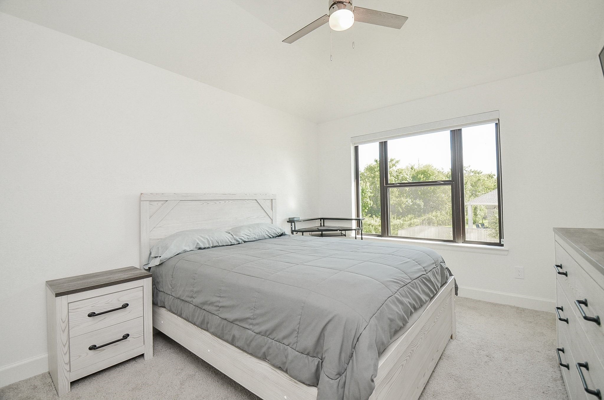 Spacious secondary bedroom with neutral finishes and abundant natural light.