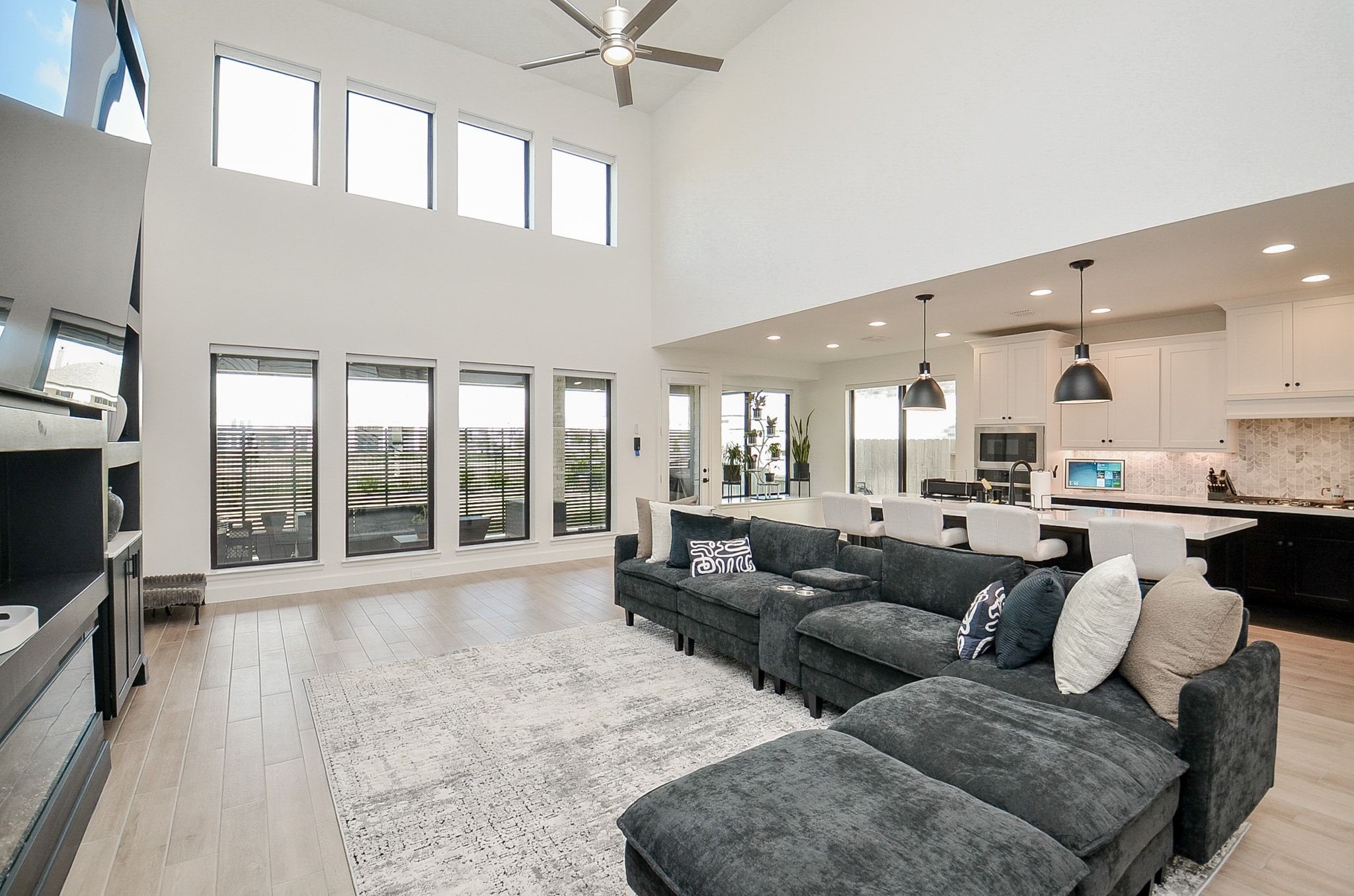 Soaring ceilings and expansive windows create a bright, airy living space.