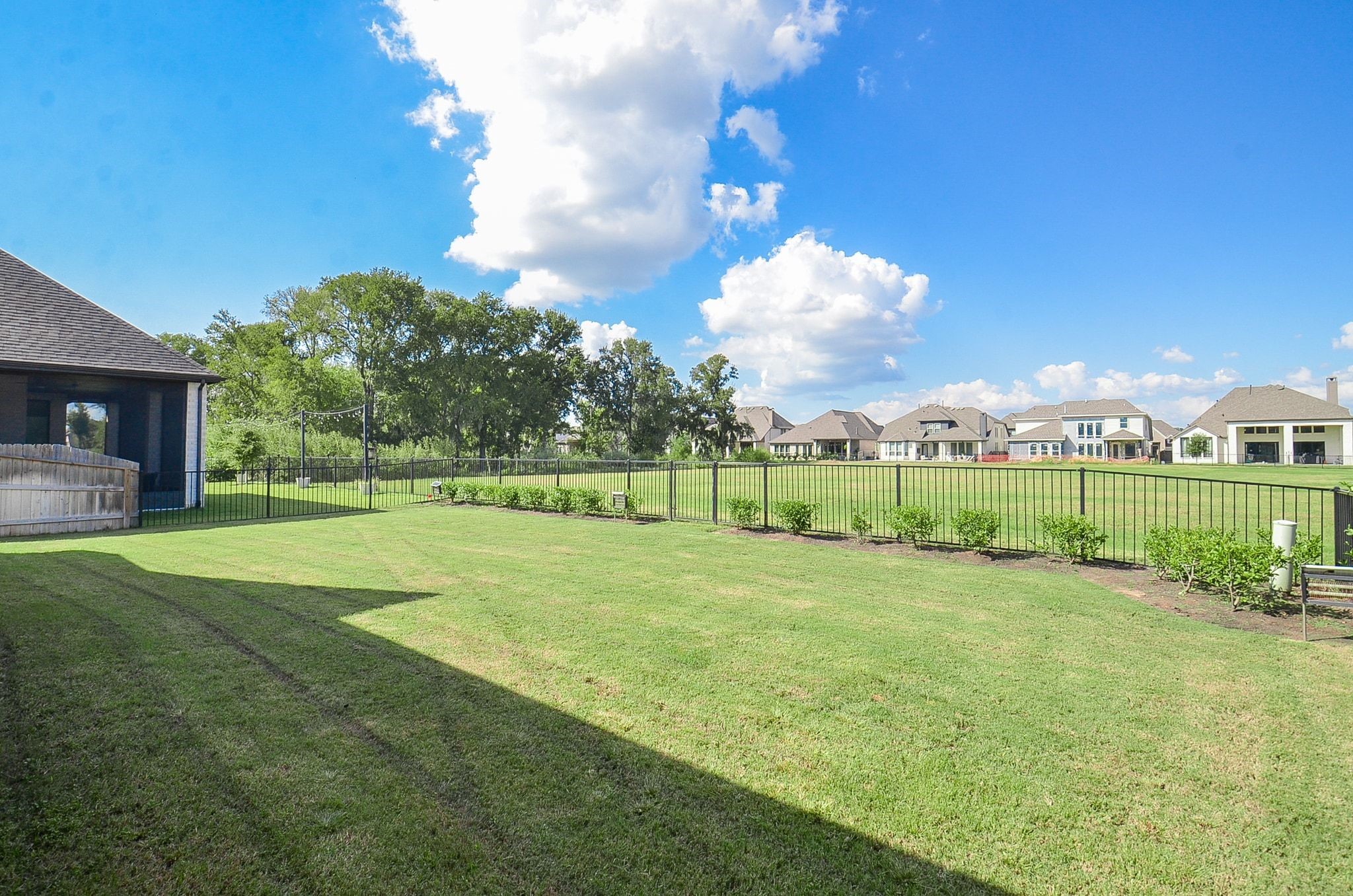 Beautifully maintained backyard overlooking expansive open green space.