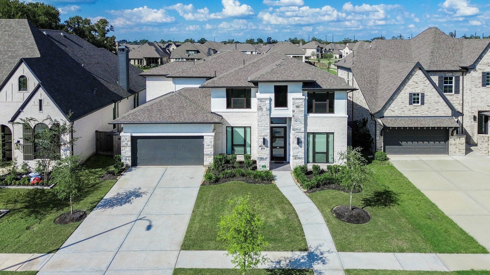 Impressive curb appeal with striking architectural lines and elegant stone accents. Impressive curb appeal with striking architectural lines and elegant stone accents.
