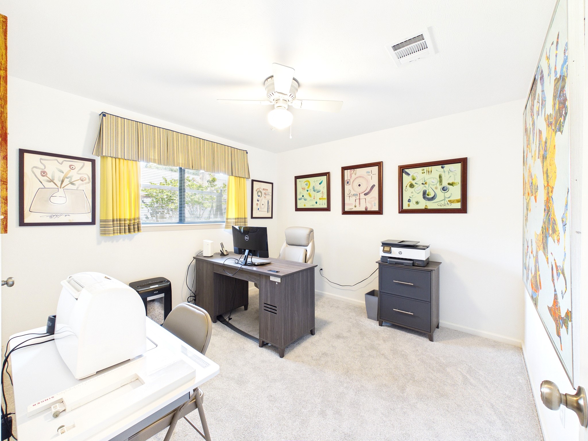 Discover the versatility of this spacious room, perfect as a productive home office or a welcoming third guest room, with ample natural light and stylish decor.