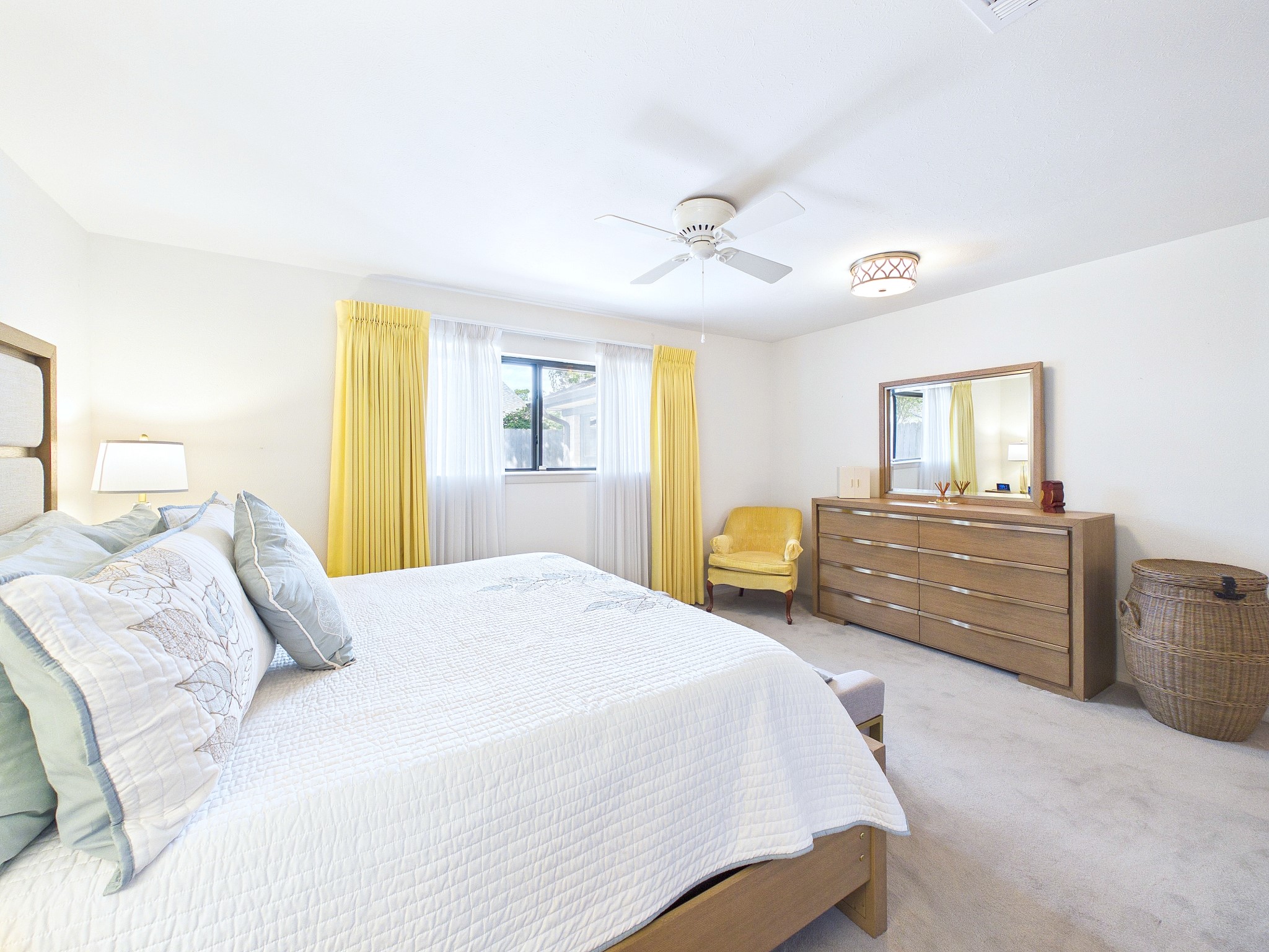 Spacious areas and lots of natural light fill this primary suite.