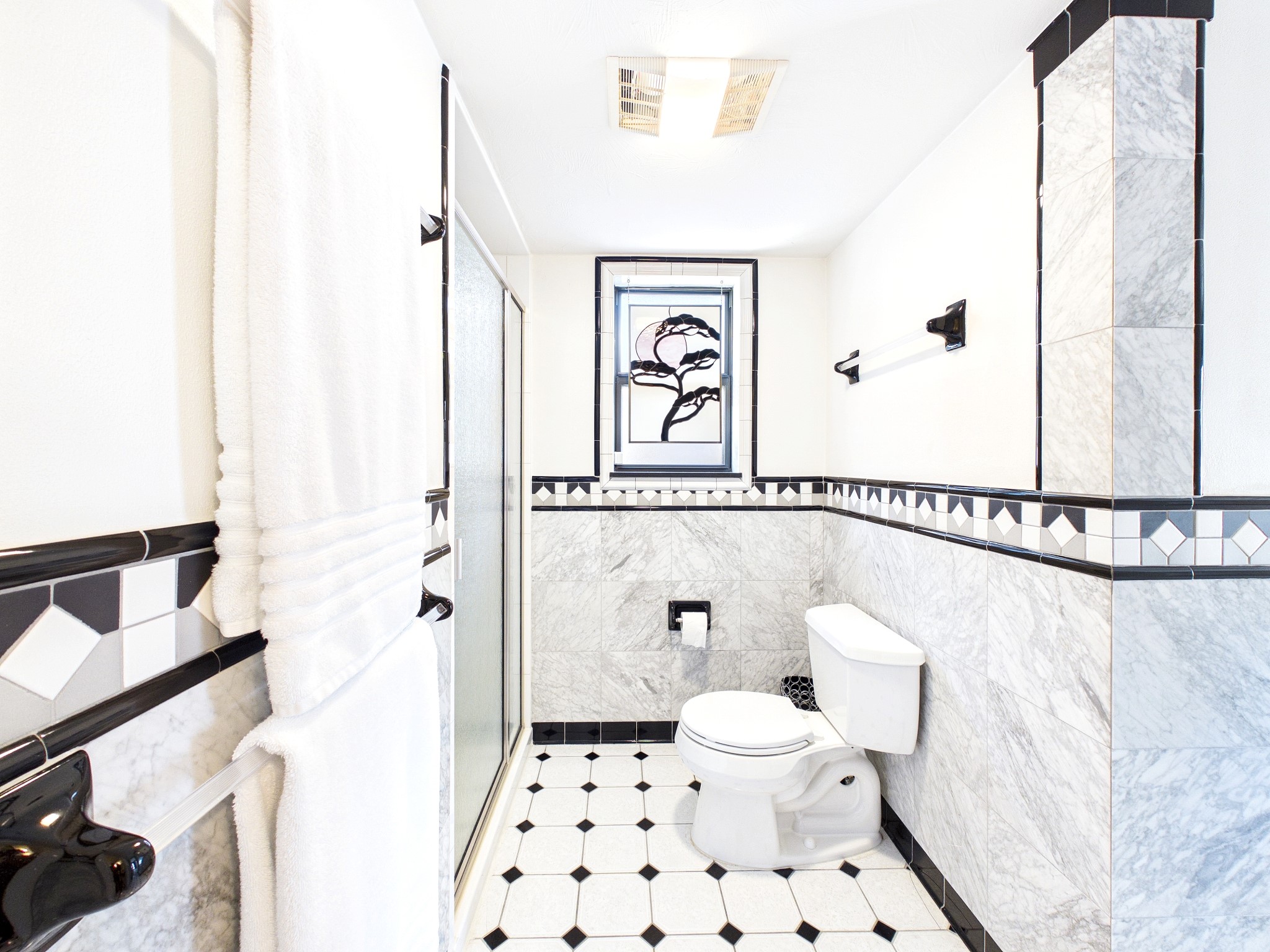Experience elegance in this bathroom, showcasing exquisite custom tile work that adds a touch of luxury and sophistication.