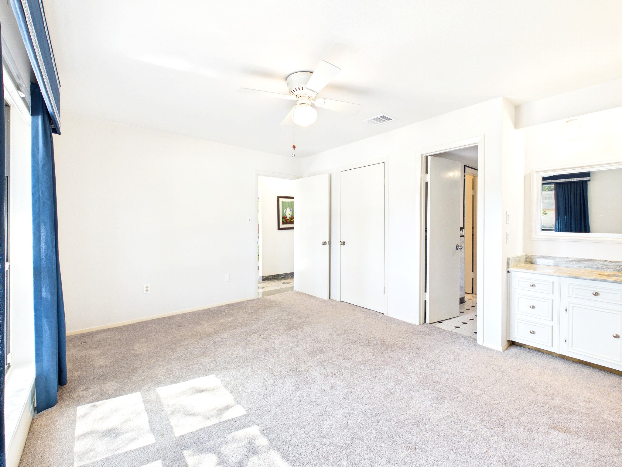 Discover a bright and airy guest room, offering ample space and comfort for visitors.