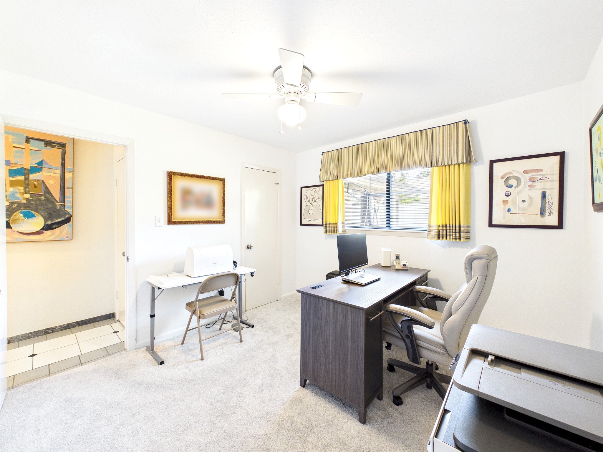 Discover a versatile space perfect for a home office or third guest room, featuring abundant natural light and a functional layout.