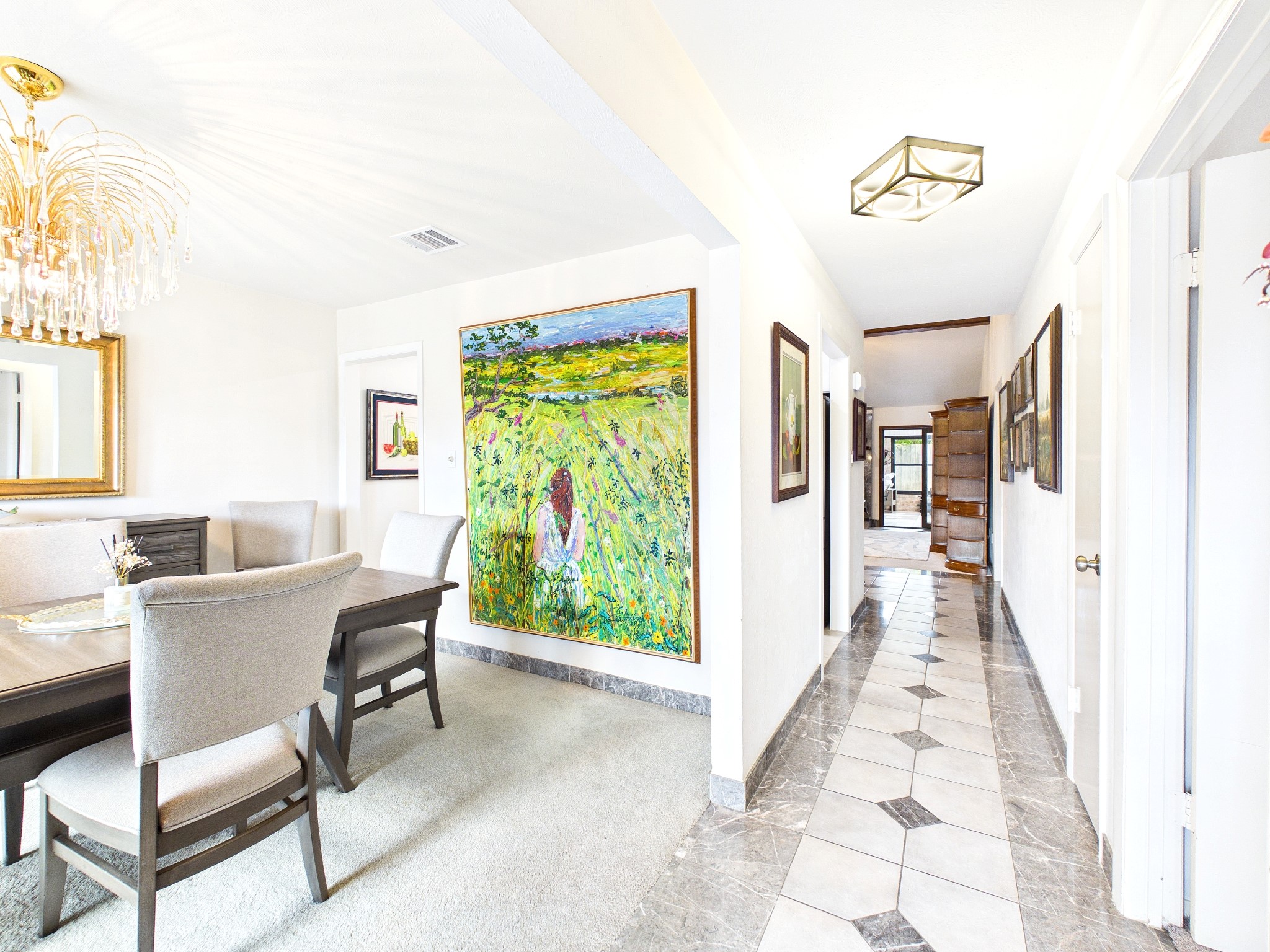Experience seamless flow in this inviting dining room with clear sight lines to the sunlit sunroom, perfect for entertaining and relaxation.