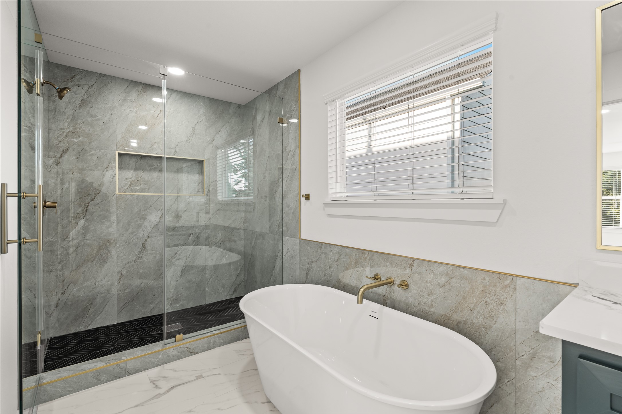 Melt the stress away. The deep, freestanding soaking tub sits perfectly beneath the window, creating your own private oasis for relaxation.