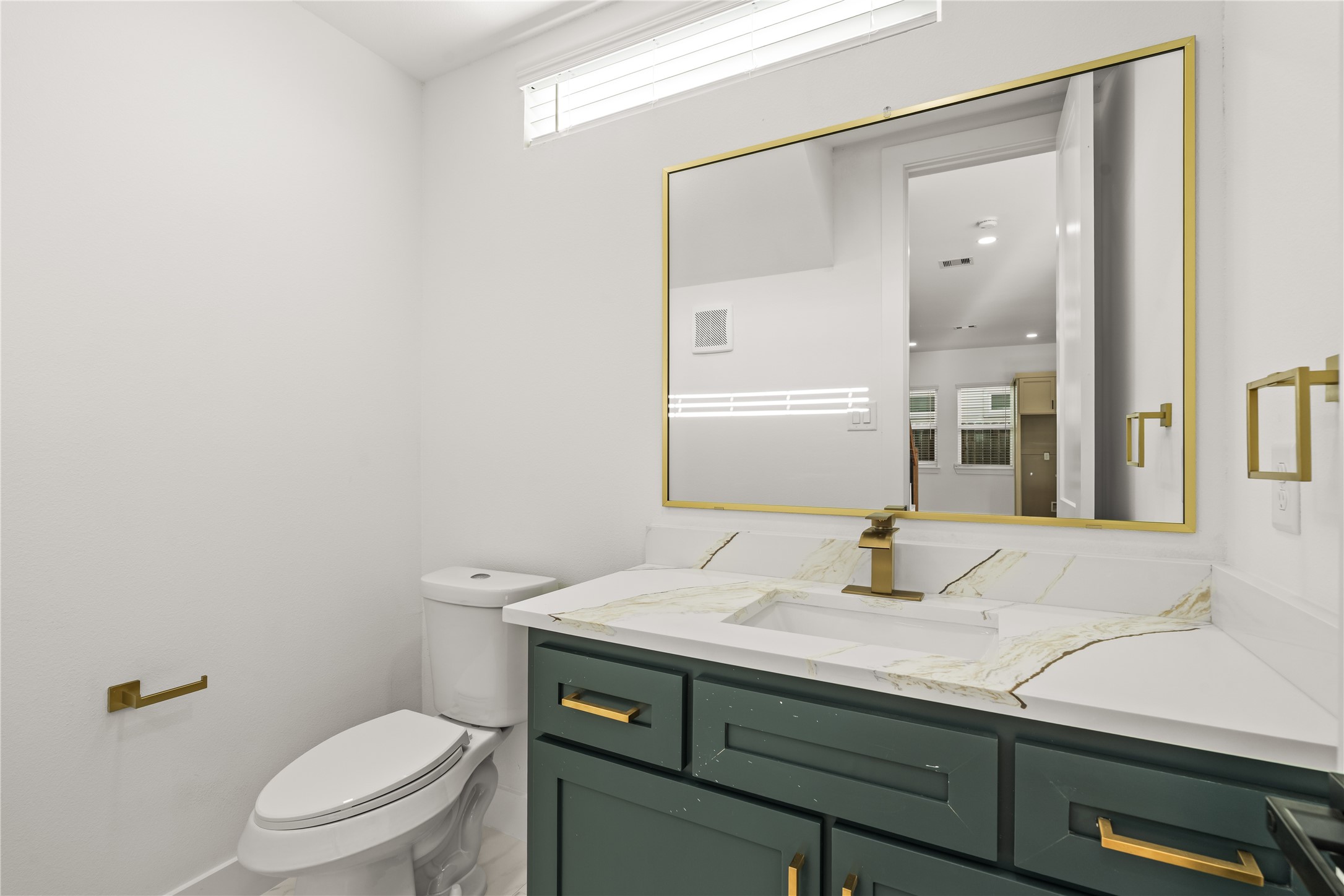A memorable guest experience. High-end accents, an oversized gold-trimmed mirror, and brilliant lighting make this compact space feel incredibly luxurious.