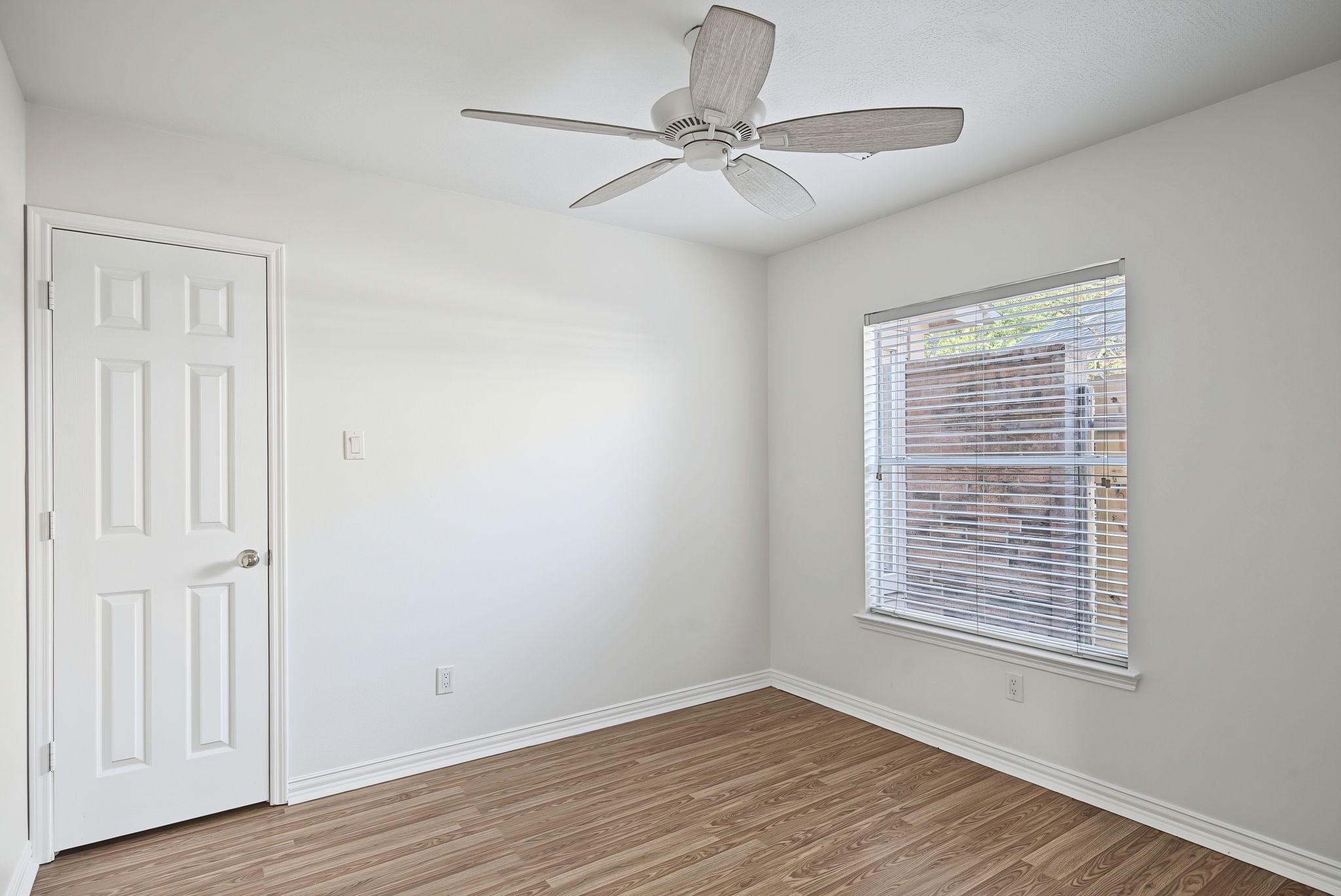 A secondary bedroom offers natural light, a closet, and a simple palette that works with a variety of decorating styles.