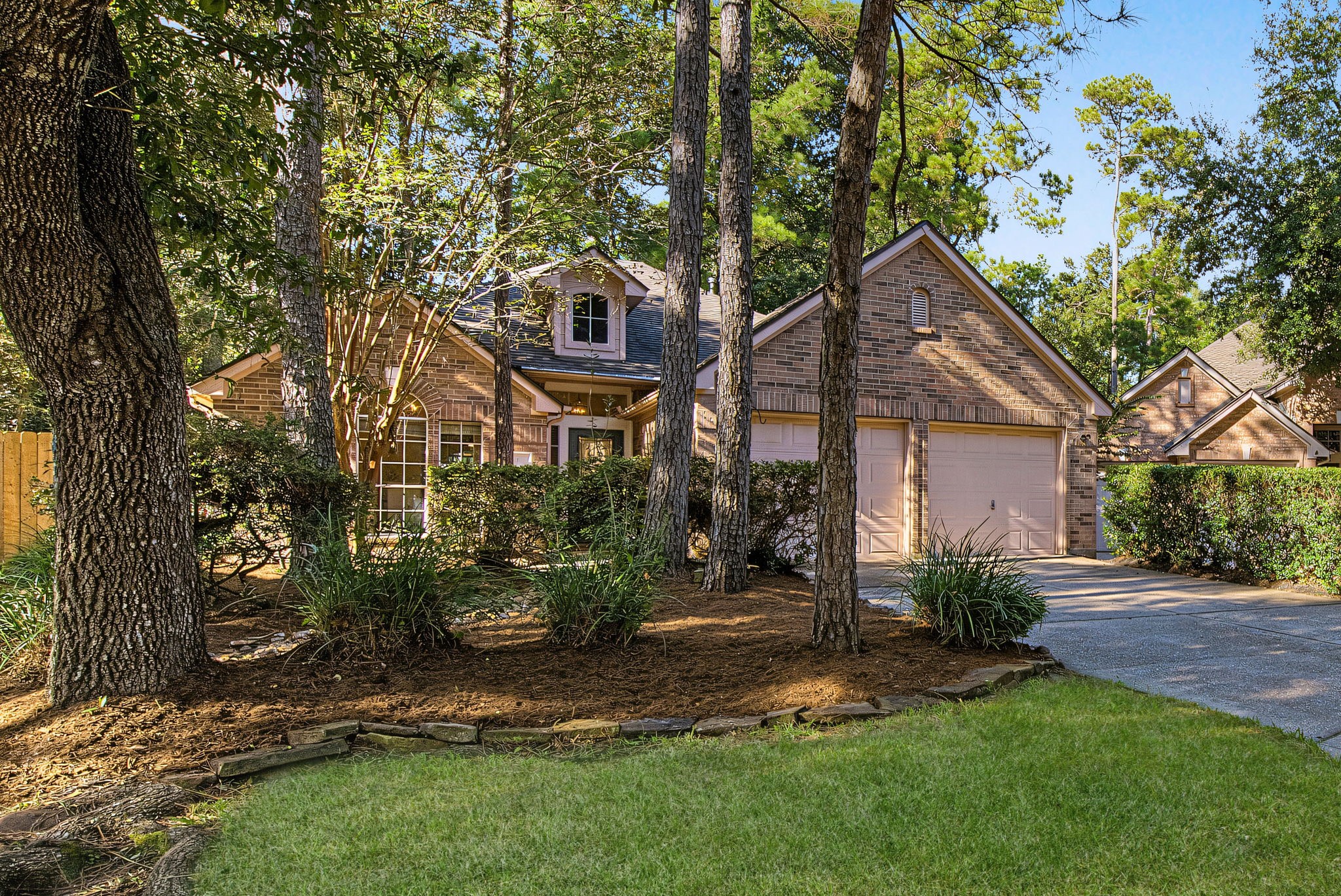 Welcome to 51 Pinery Ridge Place - classic brick charm, mature trees, and refreshed landscaping in Alden Bridge, approximately a five-minute walk to Bush Elementary.