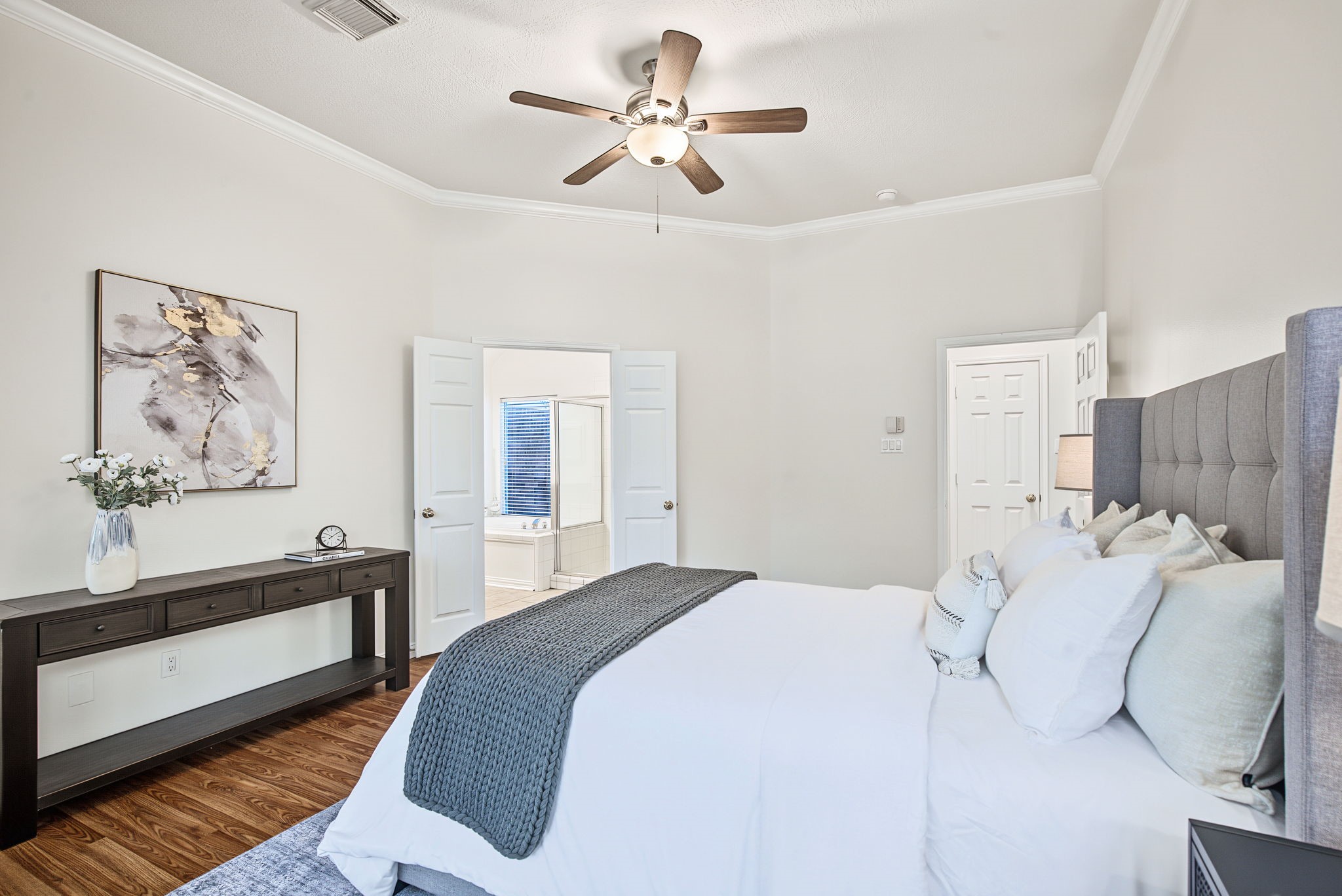 The primary suite connects directly to its bathroom, keeping your sleeping, dressing, and morning routines together.