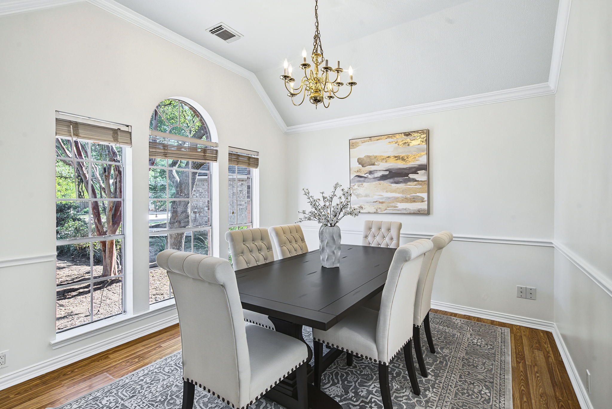 An arched window, elevated ceiling, and crown molding give the dining room a distinctive setting for holiday meals and everyday gatherings.