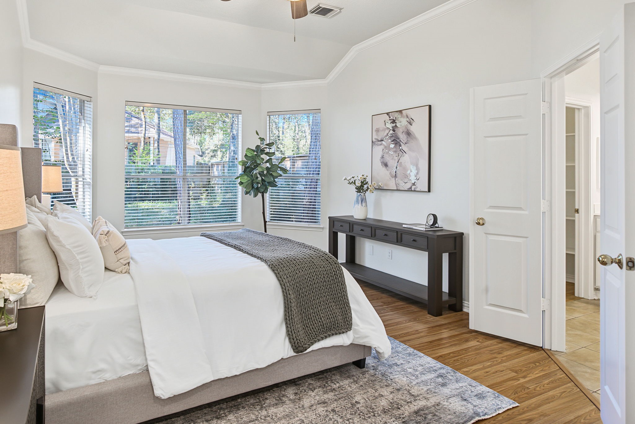 The primary bedrooms window-lined alcove offers a spot for a reading chair, morning coffee, or a quiet break at the end of the day.