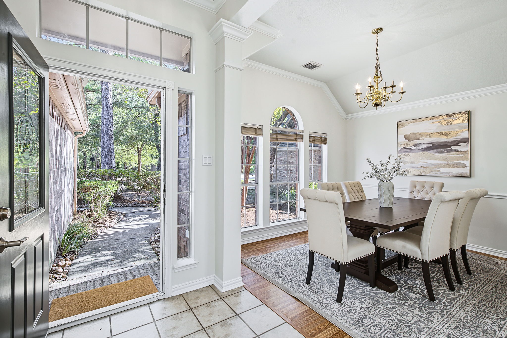 Just off the entry, the dining room welcomes guests with tall windows, natural light, and views of the landscaped front yard.